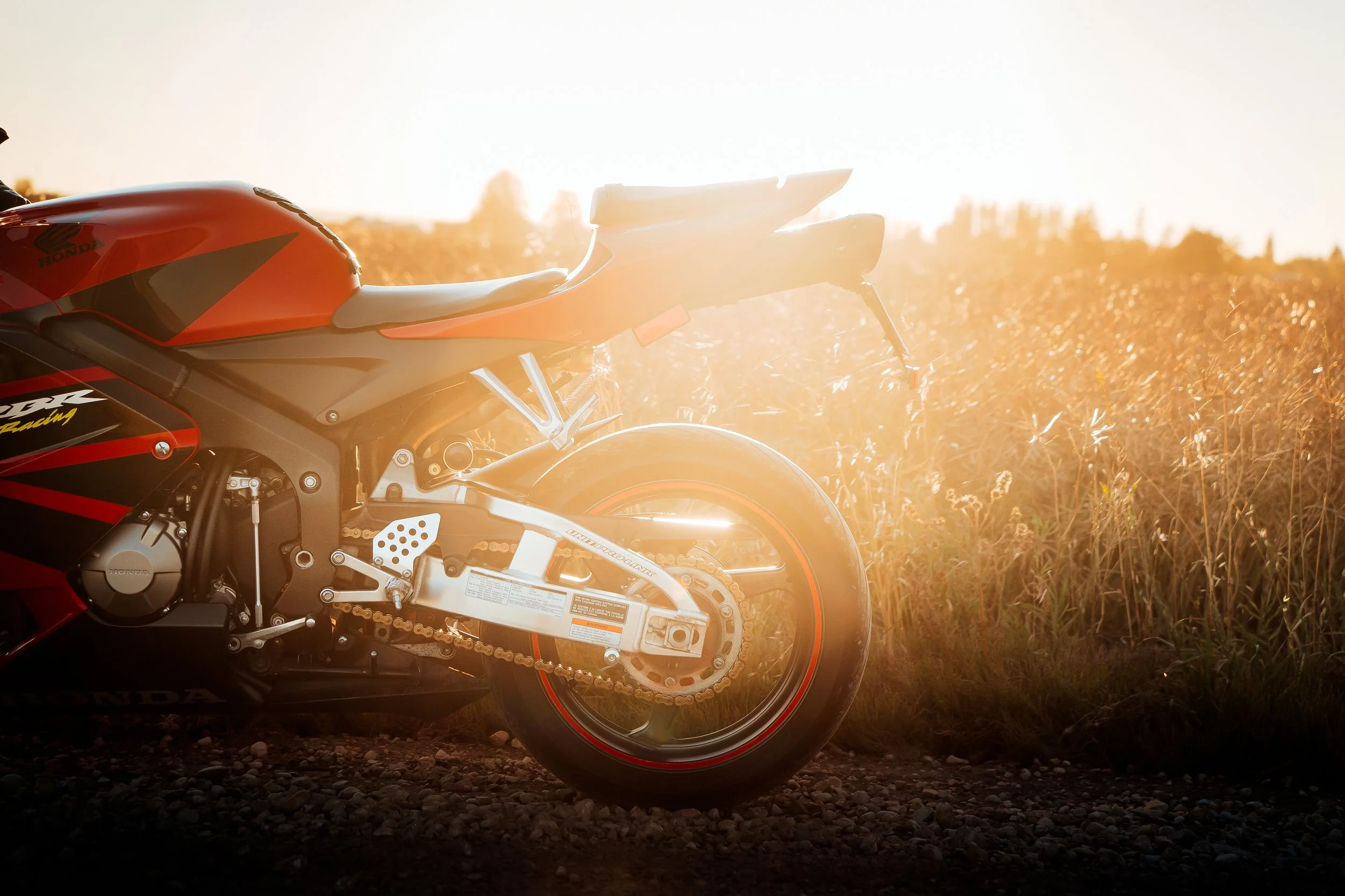 Red Honda CBR parked in front of field at sunset in Edmonton | Edmonton motorcycle photographer DarkShark Media