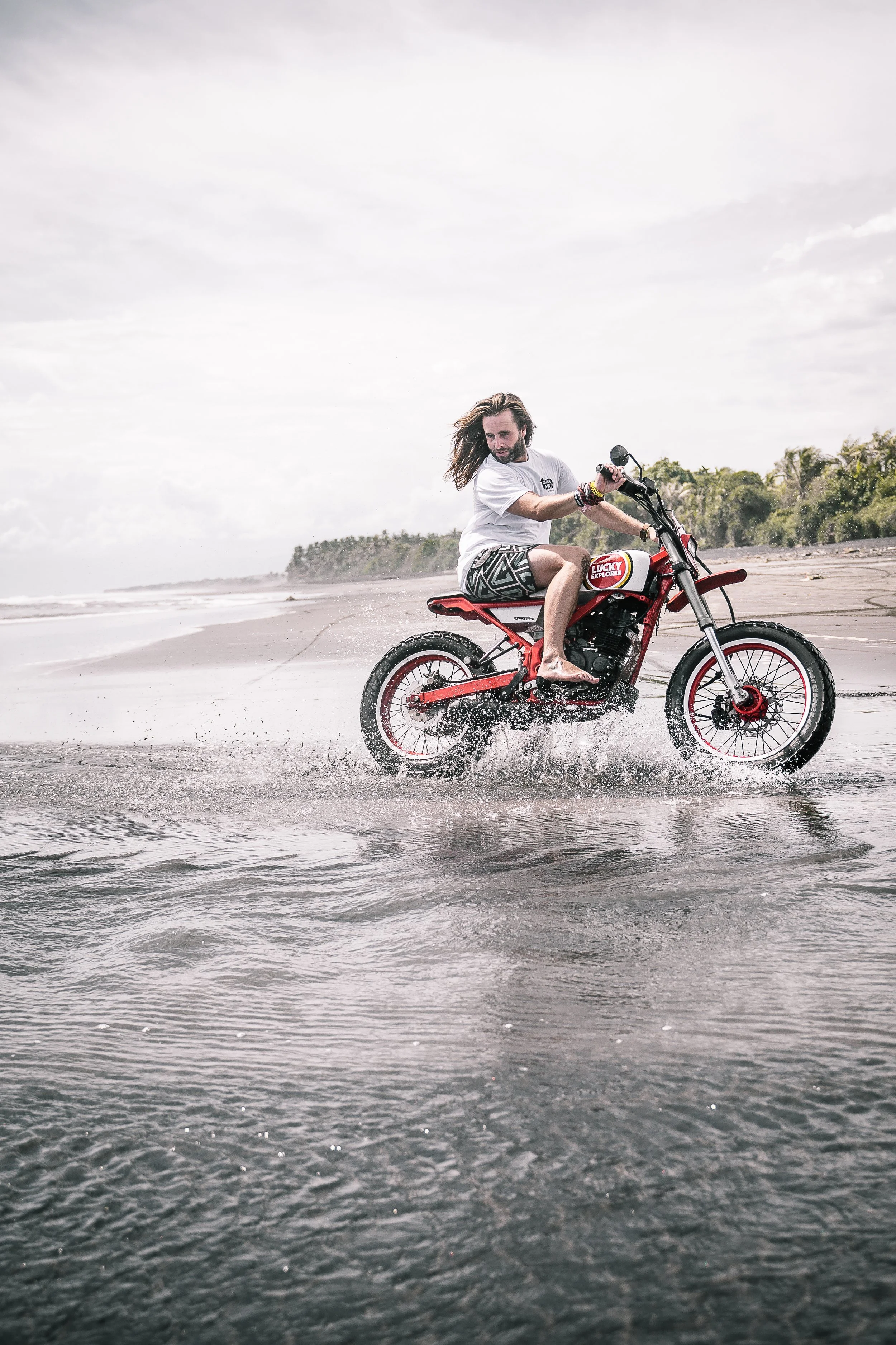 Long-haired man riding motorcycle along the beaches of Bali | Edmonton motorcycle photographer DarkShark Media