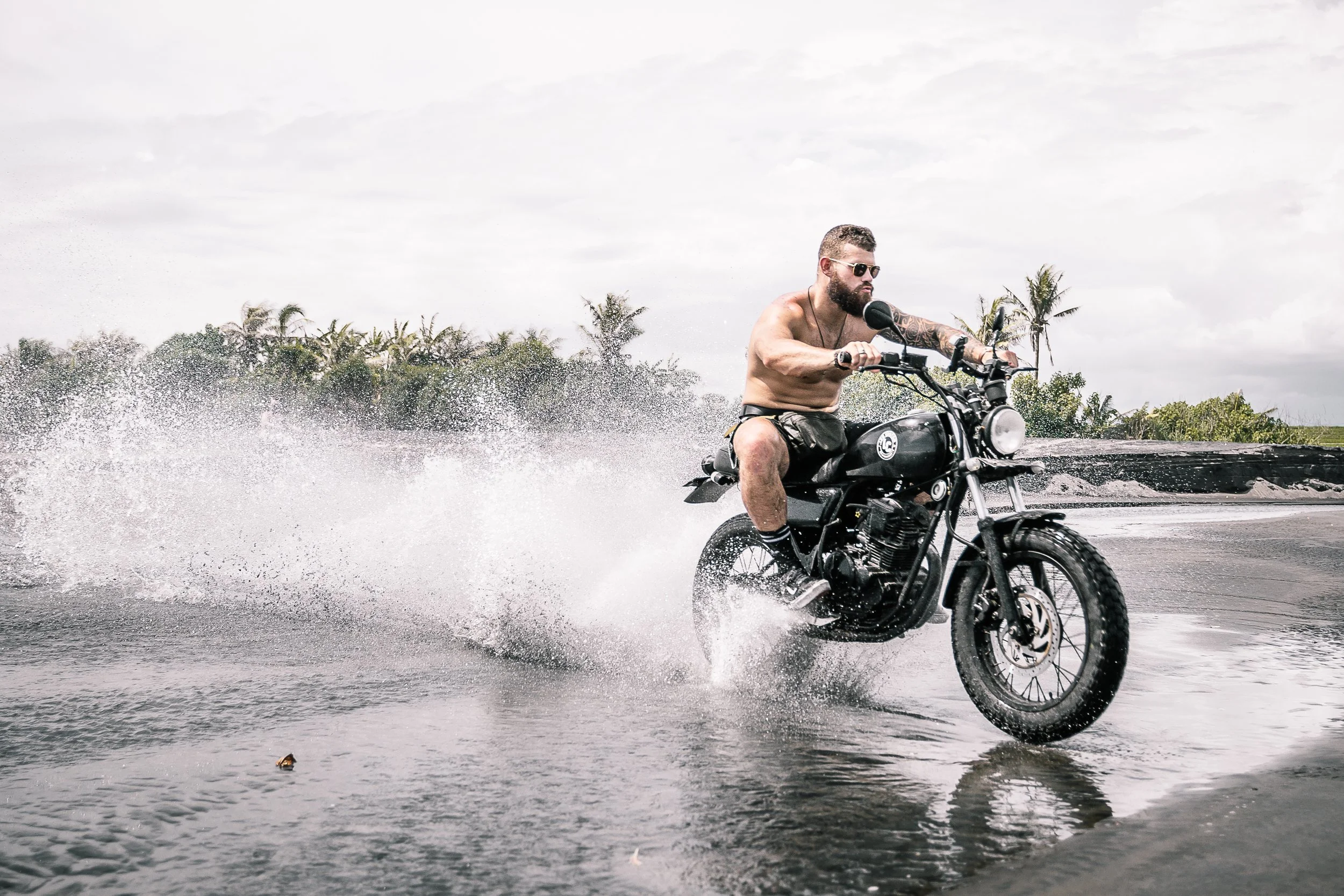 Motorcycle shoots water everywhere as man rides along the beach | Edmonton motorcycle photographer DarkShark Media