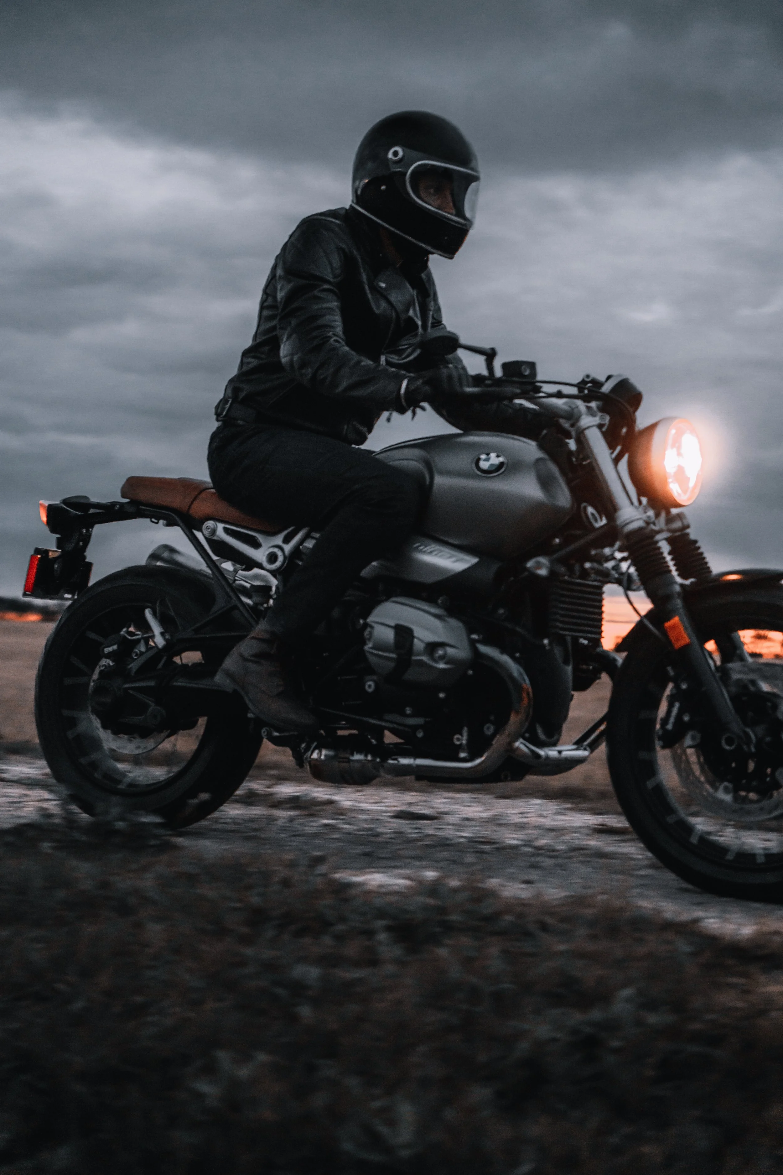 A motorcycle rider dressed in all black rides his BMW R Nine T at dusk | Edmonton motorcycle photographer DarkShark Media