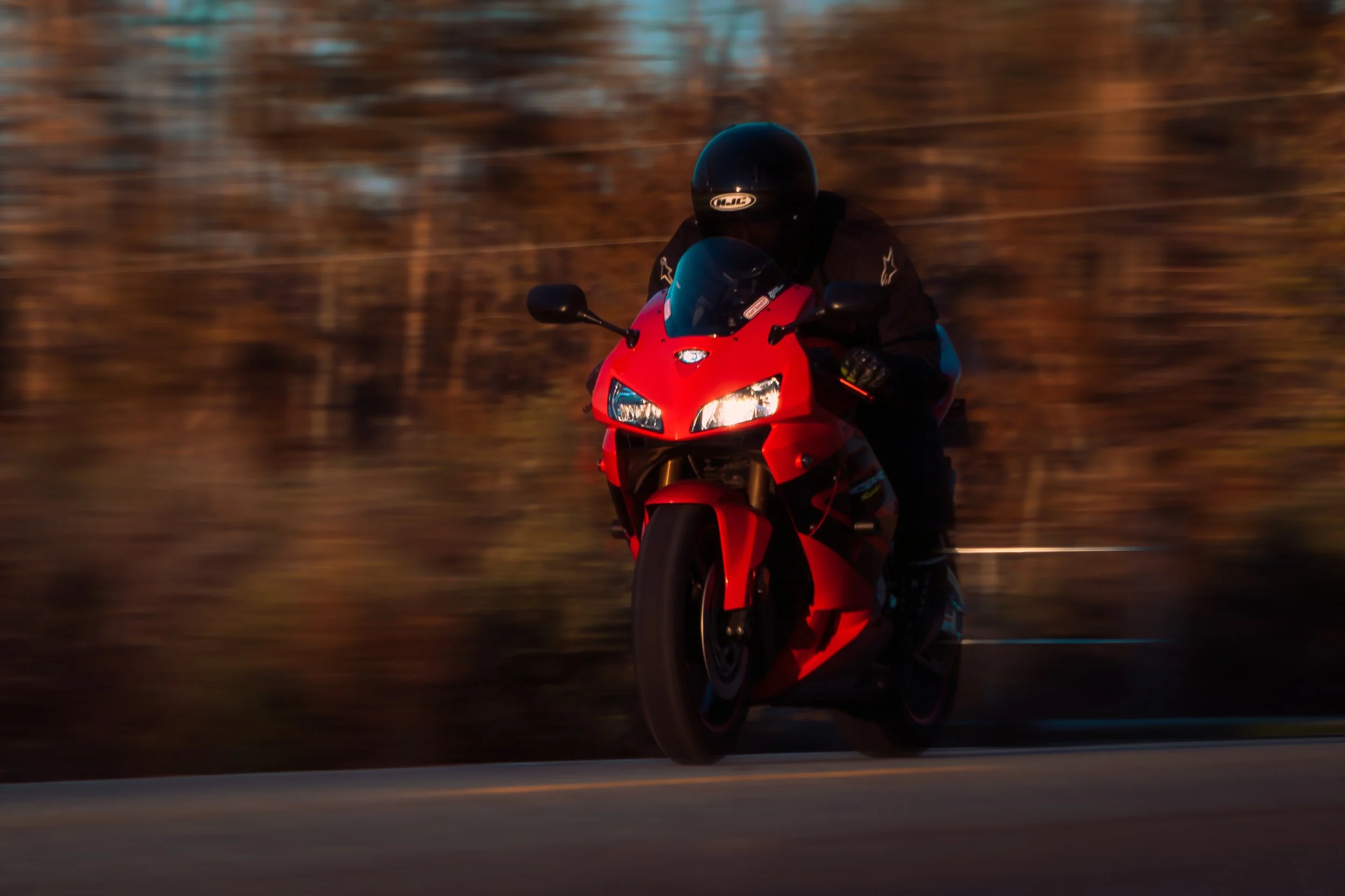 Red Honda CBR riding down highway | Edmonton motorcycle photographer DarkShark Media