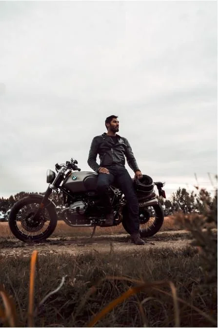 A male model poses on BMW motorcycle in field | Edmonton motorcycle photographer DarkShark Media