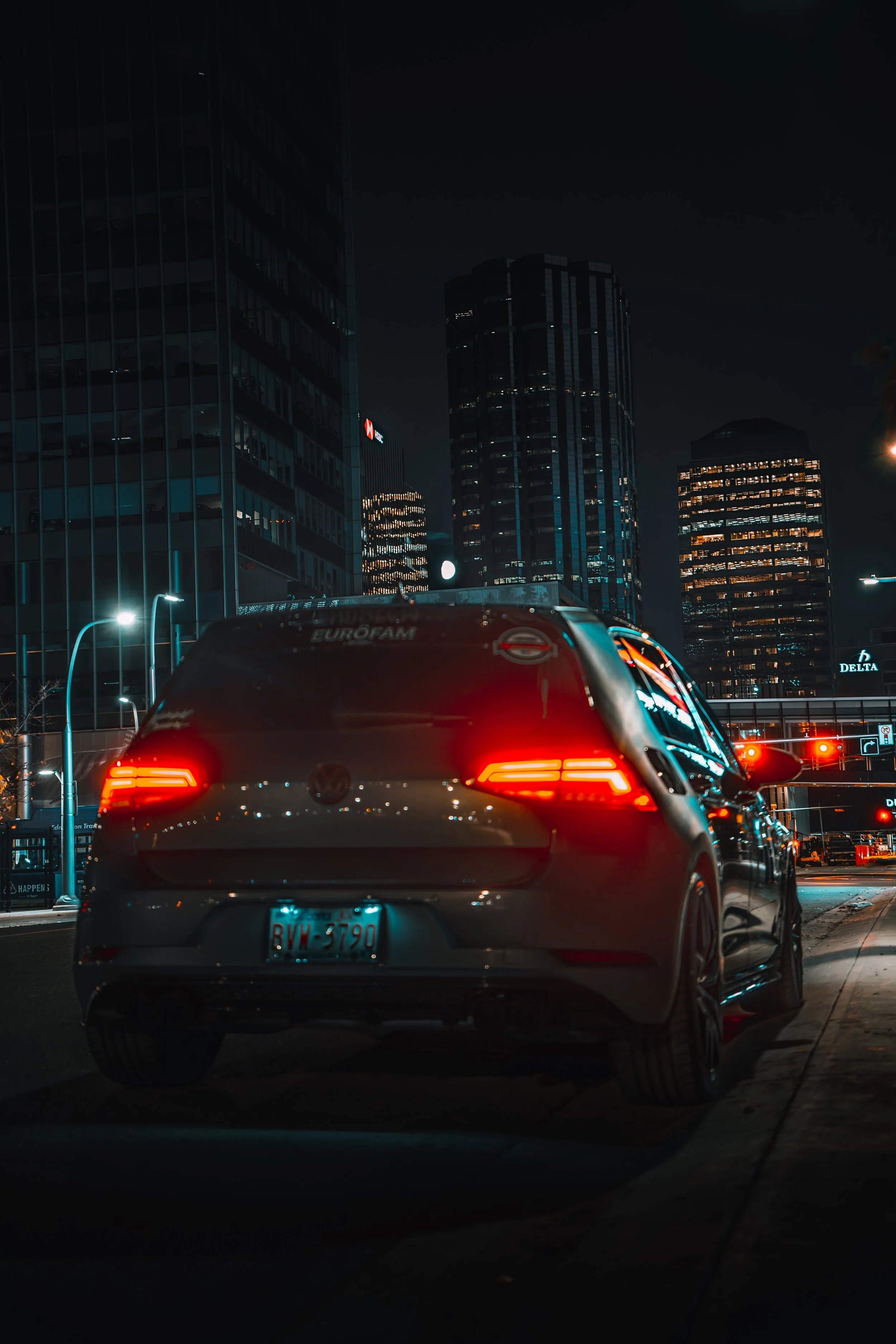 Volkswagen Golf with skyscrapers of downtown Edmonton in background | Edmonton automotive photographer DarkShark Media