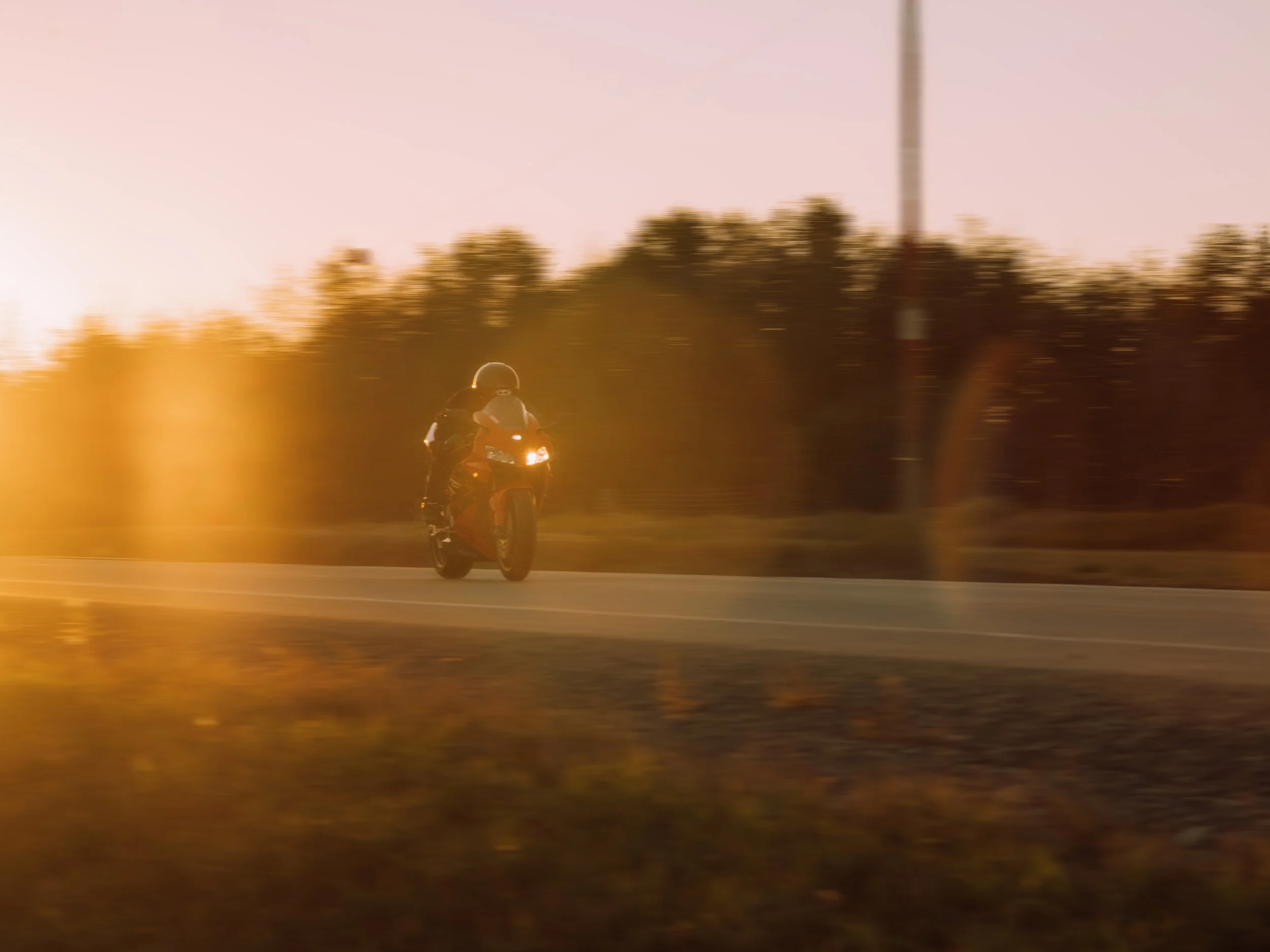 Red Honda CBR riding on highway at sunset | Edmonton motorcycle photographer DarkShark Media
