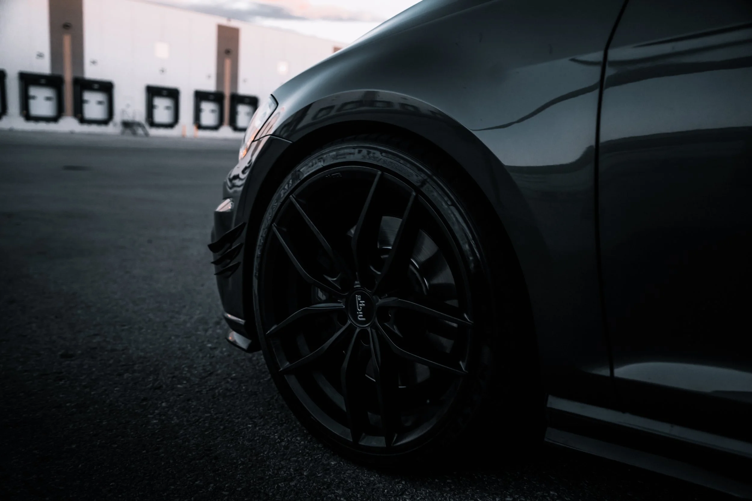 Custom wheels on Volkswagen Golf in front of warehouse | Edmonton automotive photographer DarkShark Media