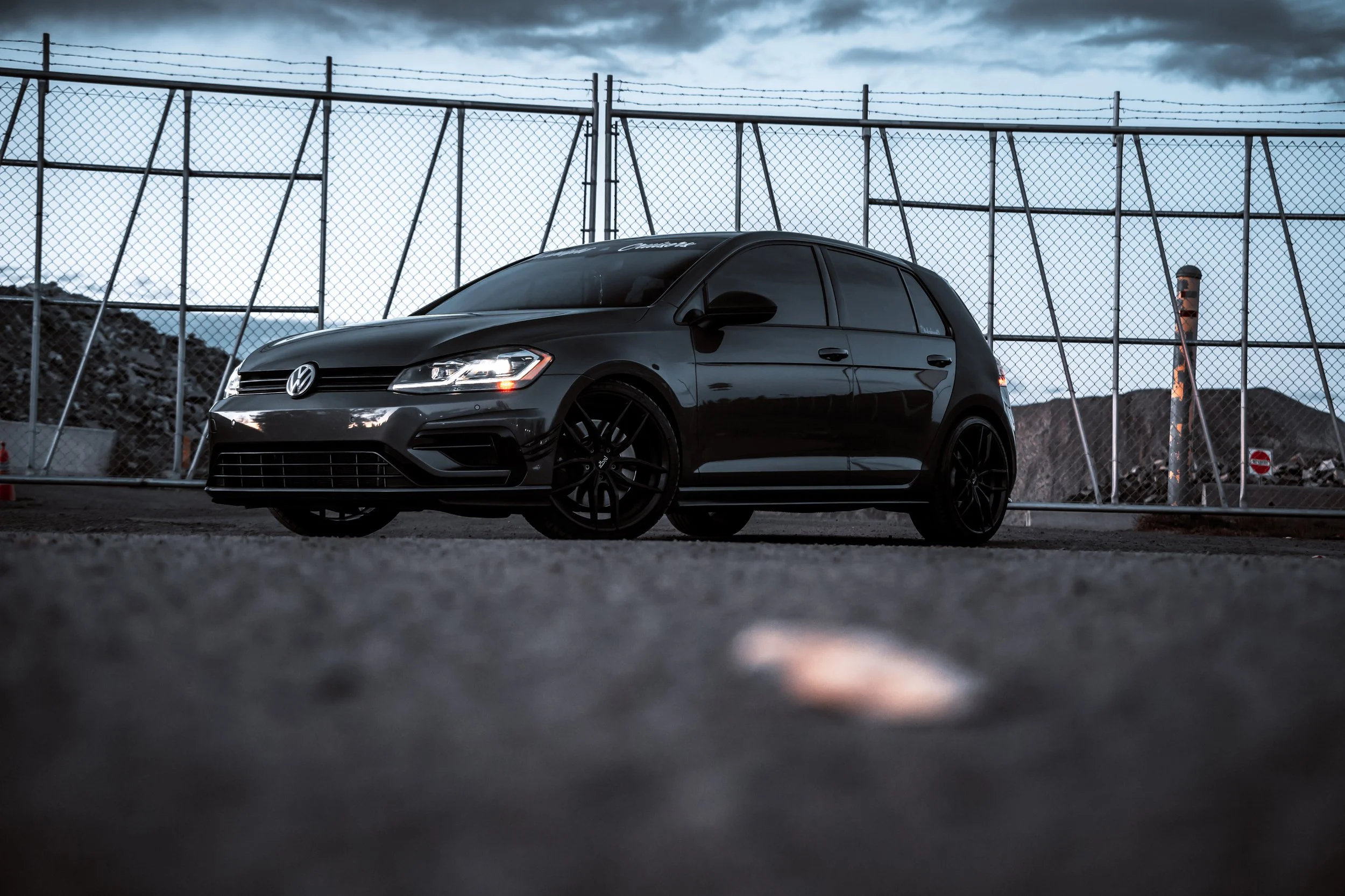 Volkswagen Golf parked in front of gate at Edmonton concrete recycling depot | Edmonton automotive photographer DarkShark Media