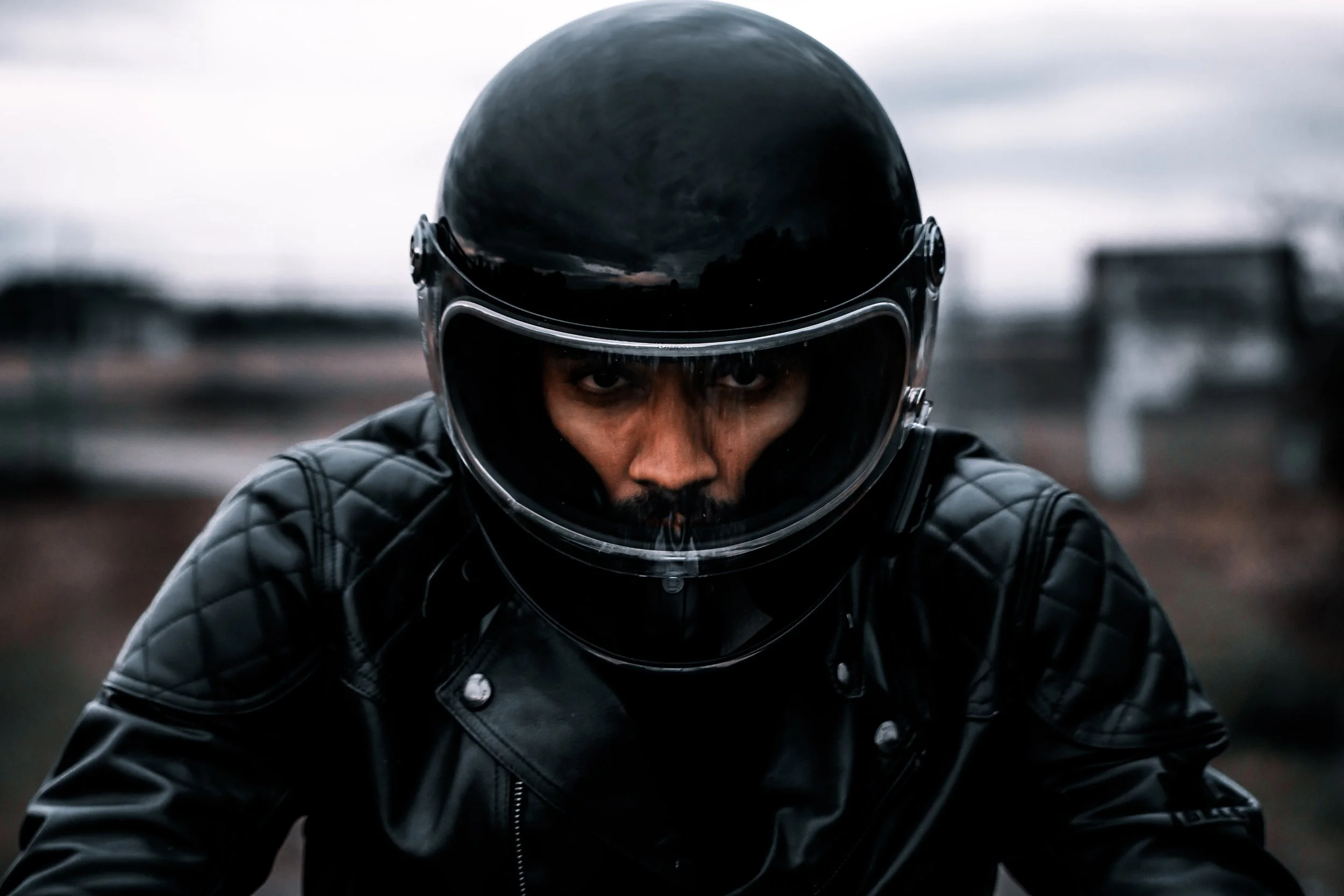 Face of motorcycle rider in helmet wearing all black | Edmonton motorcycle photographer DarkShark Media