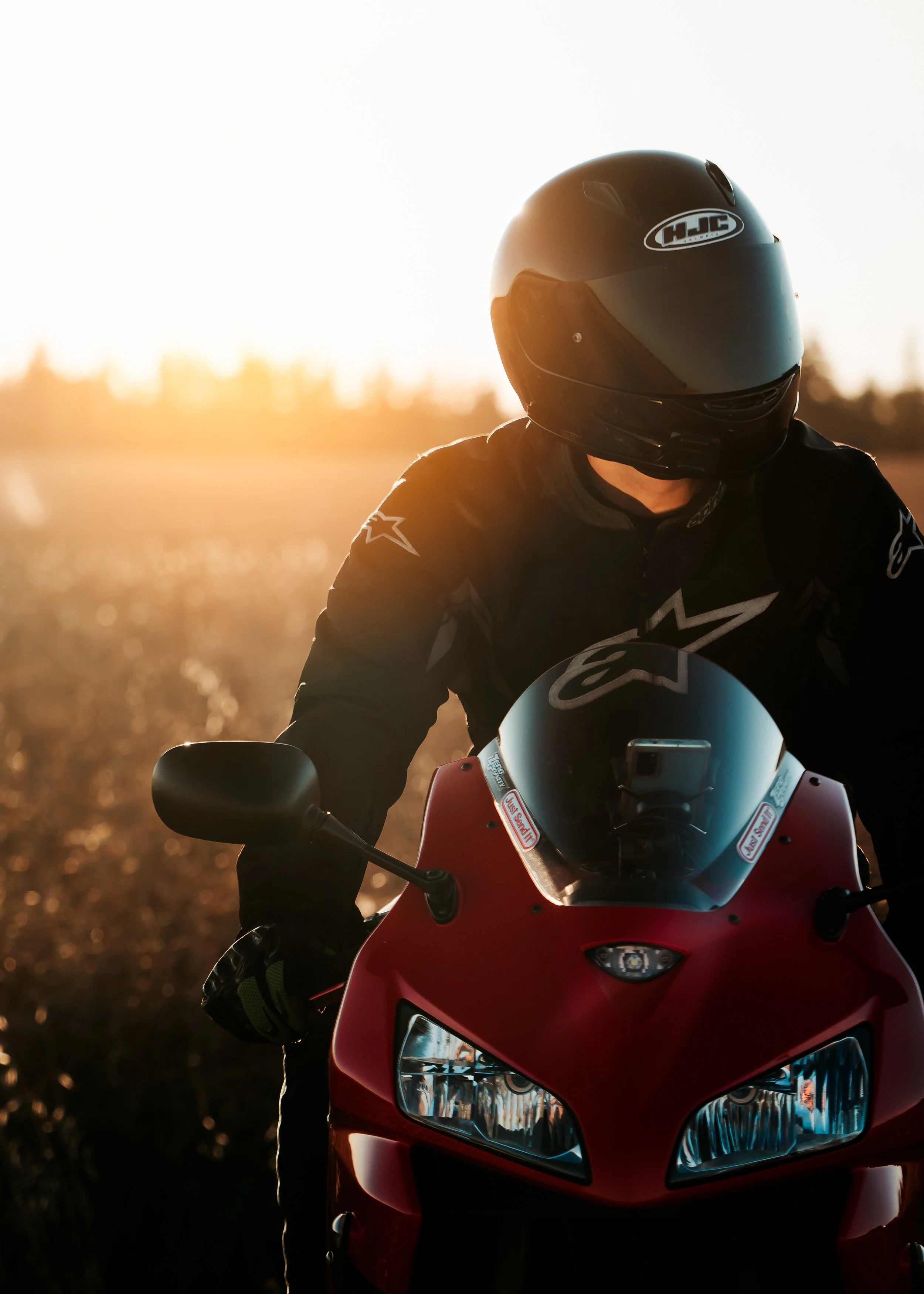 Motorcycle rider on Honda CBR at sunset in front of field | Edmonton motorcycle photographer DarkShark Media