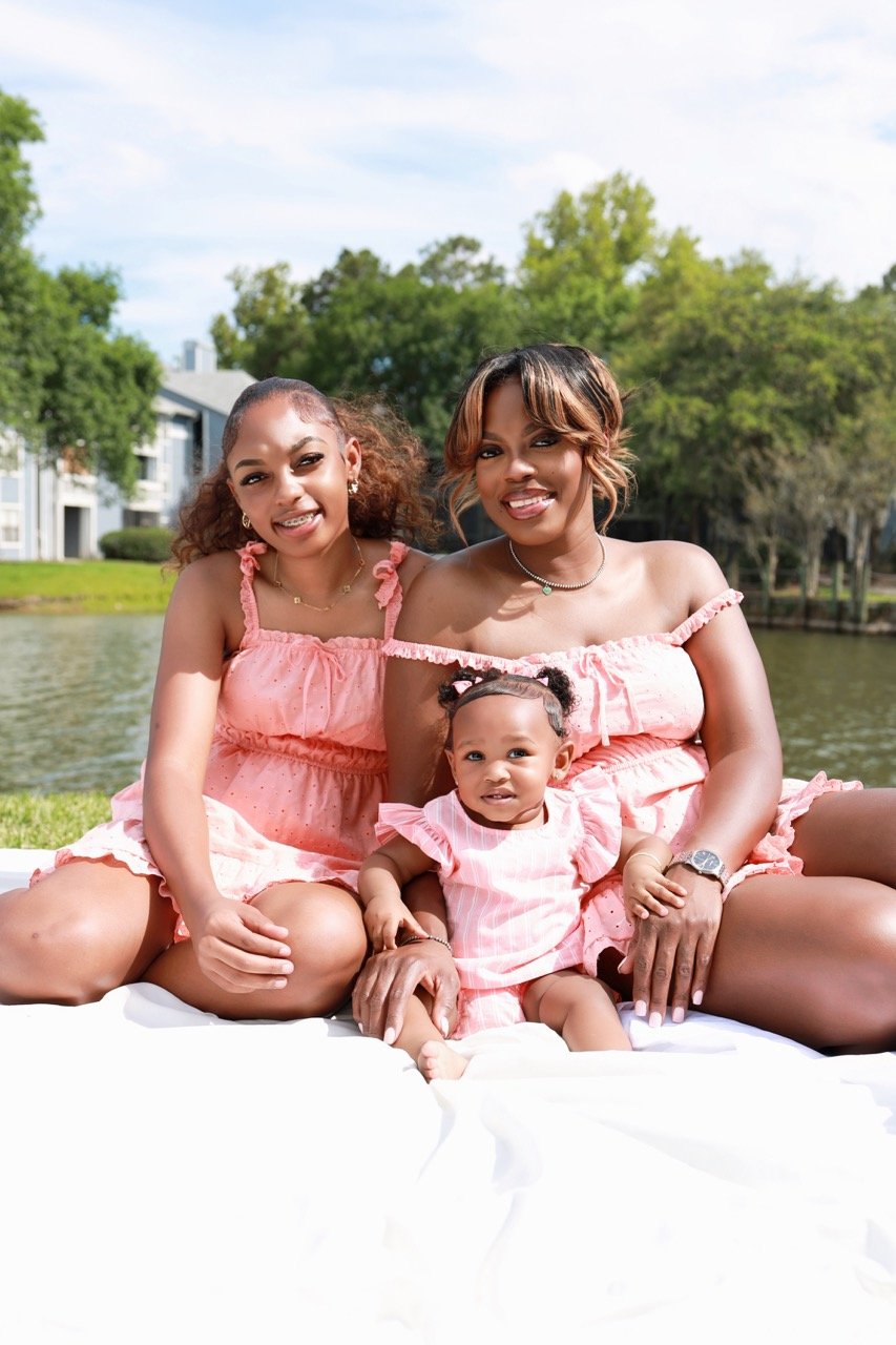 Lifestyle family portrait photographed outdoors by QDot Productions in Florida.