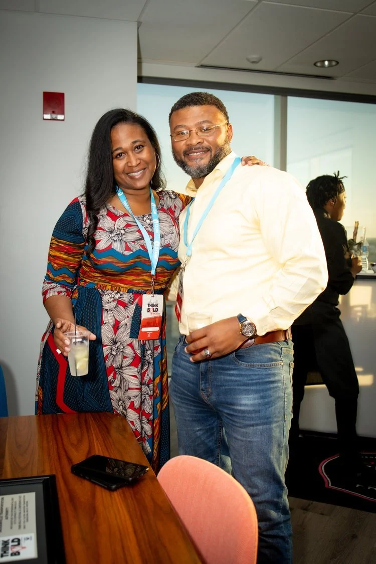 Two attendees smiling at a corporate networking event, photographed by QDot Productions