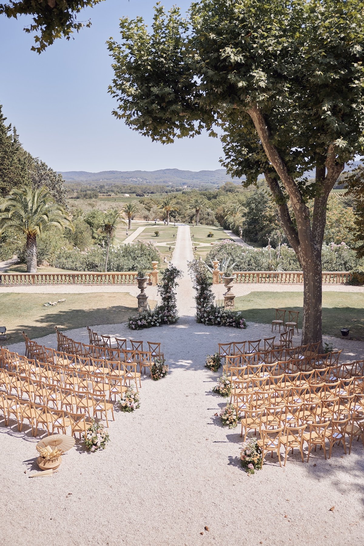 Outdoor wedding ceremony overlooking rolling hills at a luxury Tuscany destination wedding venue.