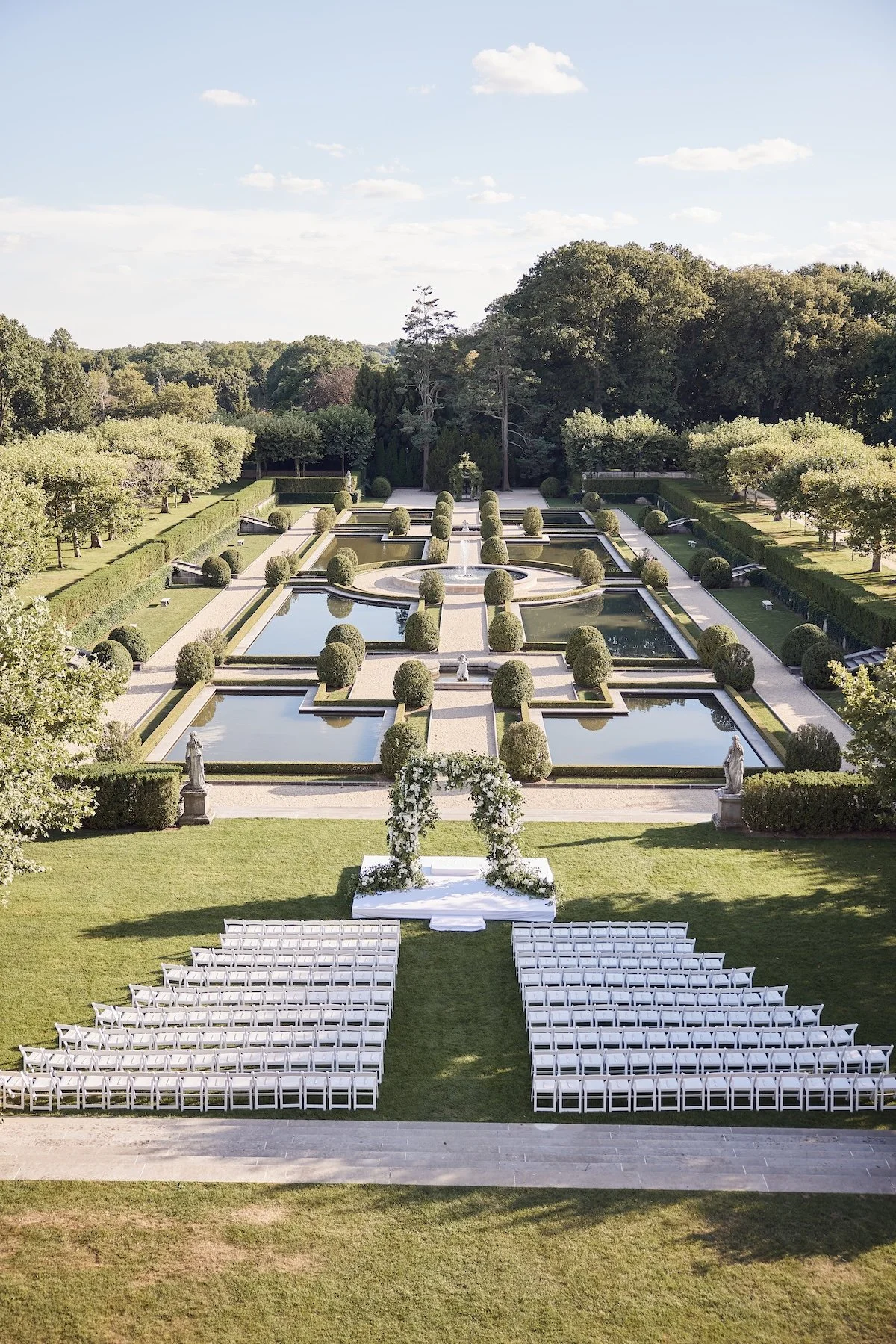 Formal garden ceremony layout at Oheka Castle, an iconic destination wedding venue.