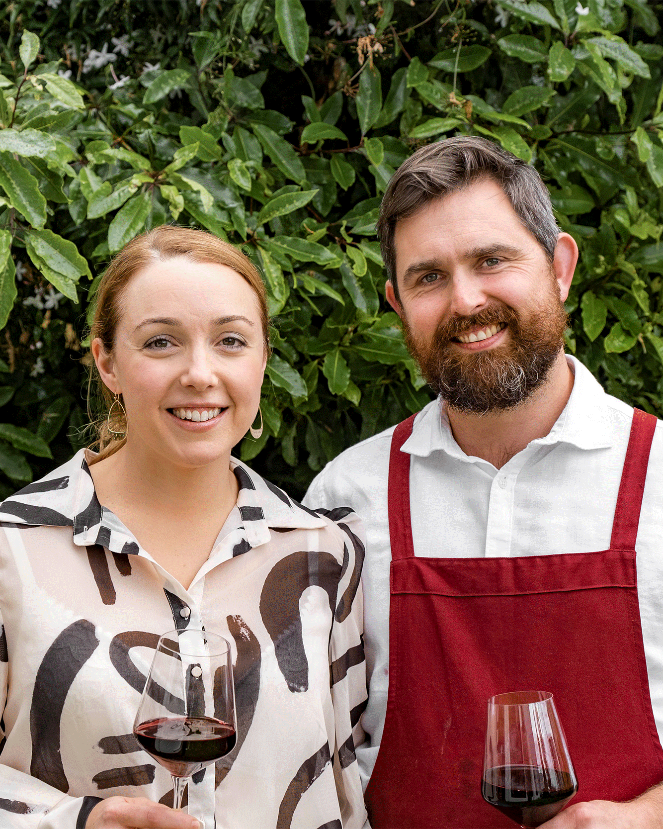 A GIF of Sean and Liz smiling, toasting and laughing