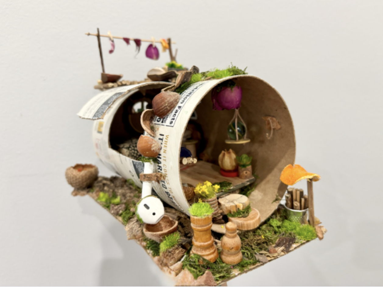 Clara Campos
Oat House, 2026
Quaker Oats container, tree bark, dried flowers, artificial moss, paper, coffee stirrers, buttons, beads, fabric
11.5 x 6.5 x 5 in