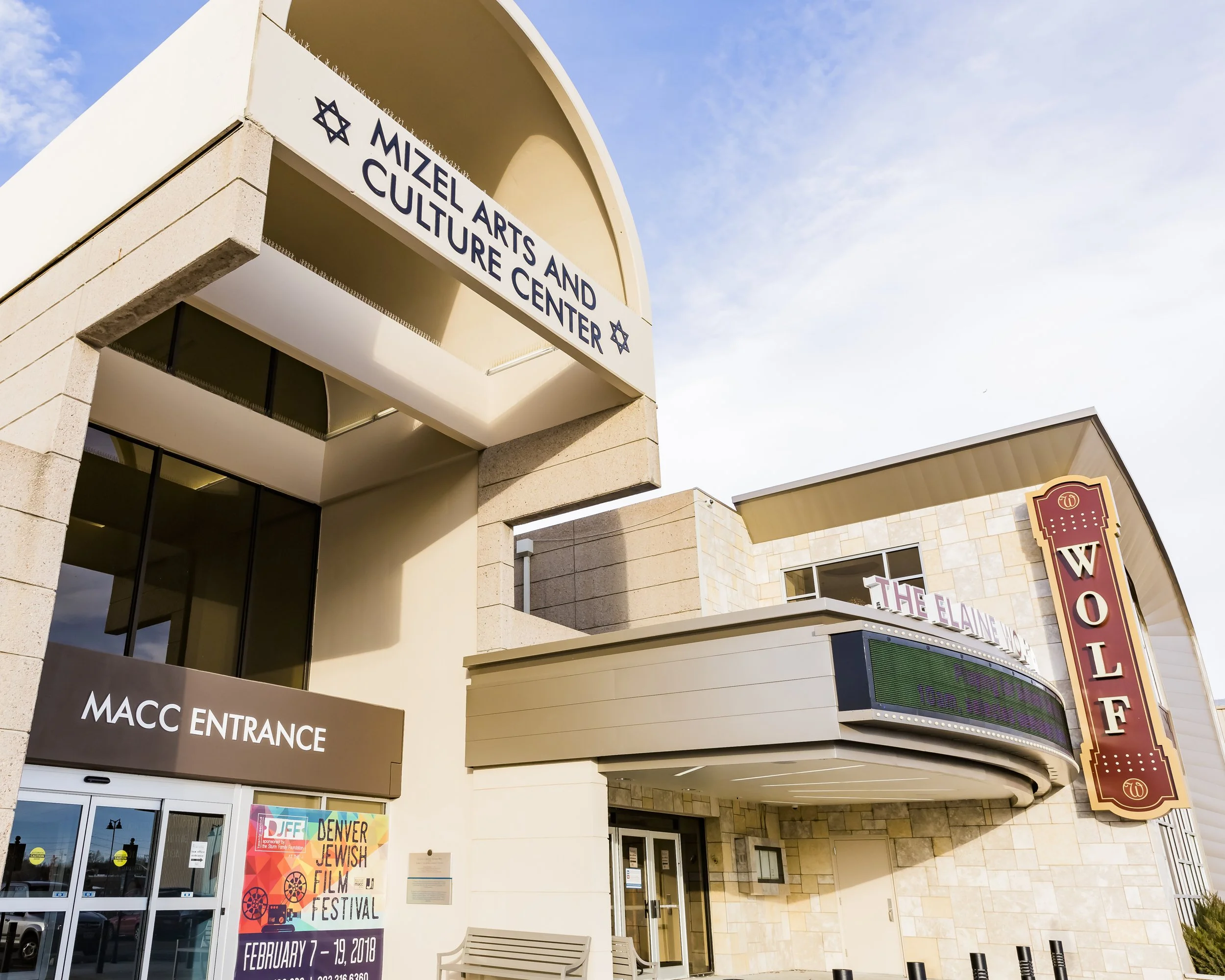 Exterior view of the Mizel Arts and Culture Center at the Jewish Community Campus in Denver, Colorado, showing the signage, the entrance, and the hotel sign on the right.