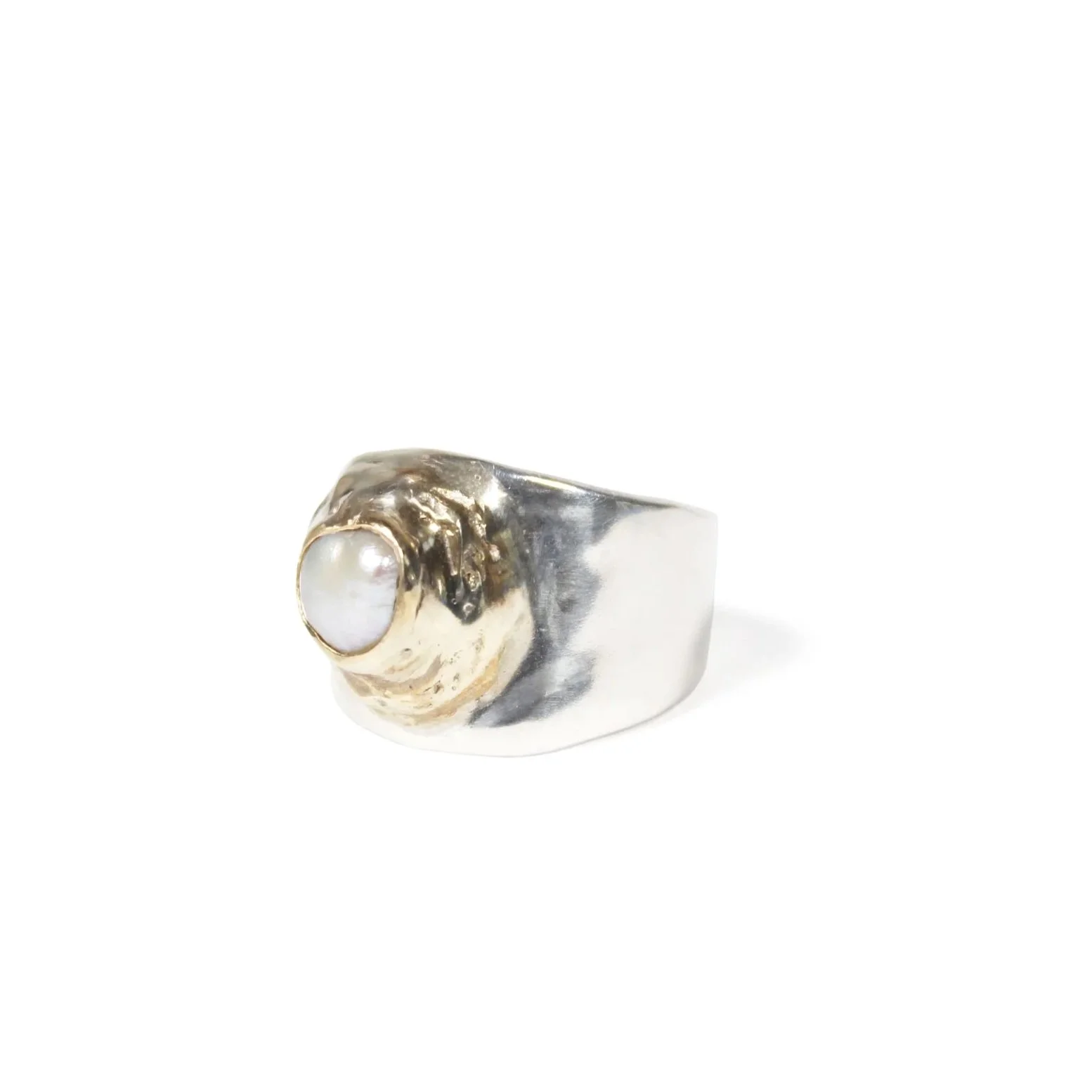 A wide silver band, featuring a soft, molten texture & freshwater pearl in brass setting.