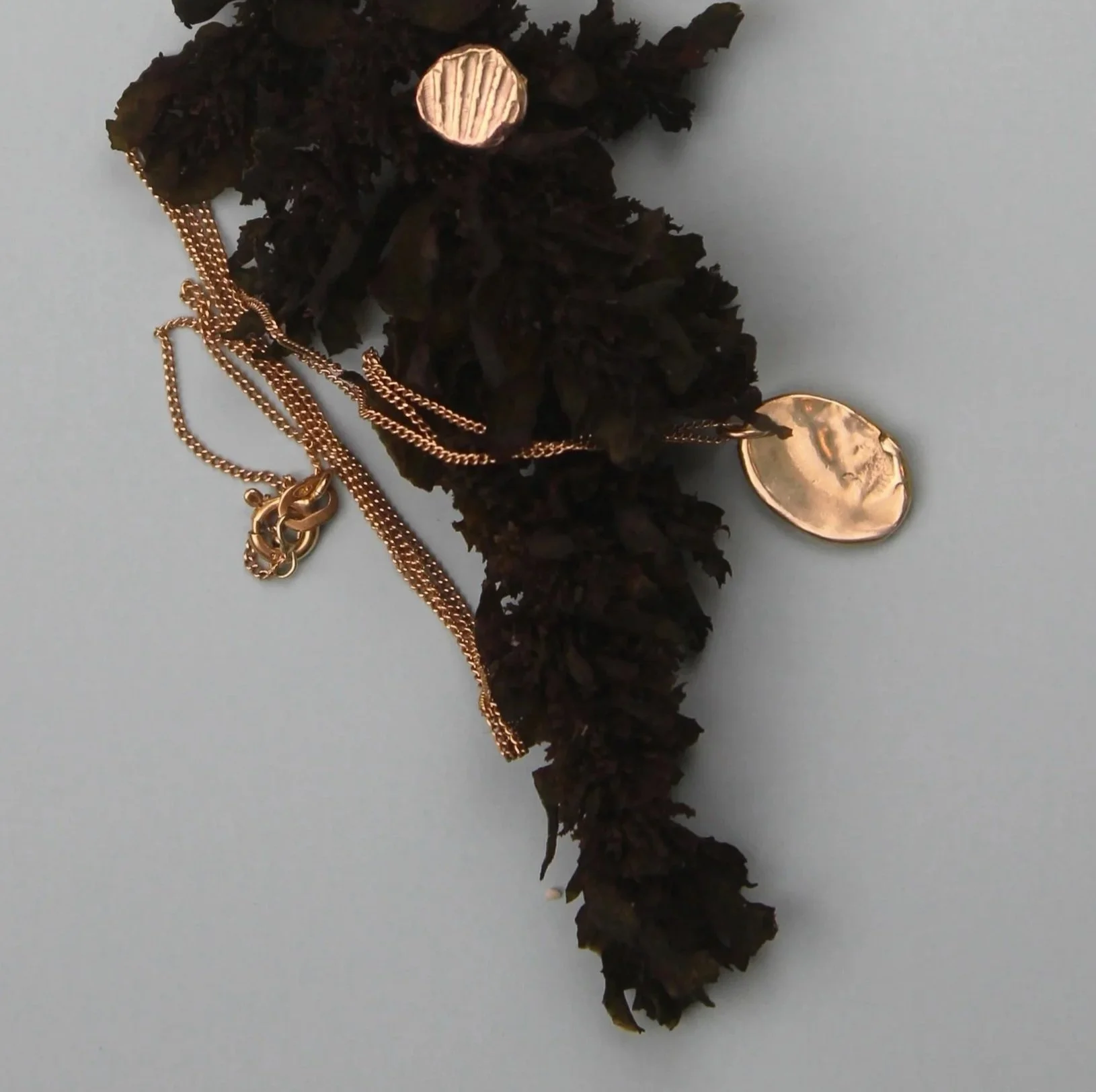 flatlay featuring gold necklace with water-like texture