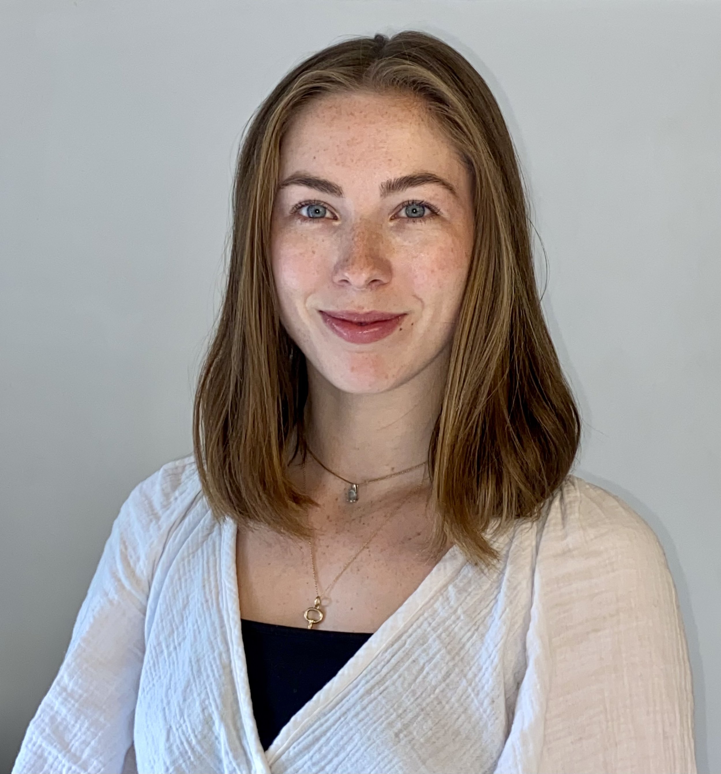 Dr. Rebecca O’Sullivan, an experienced counseling psychologist, smiling in her therapy office.
