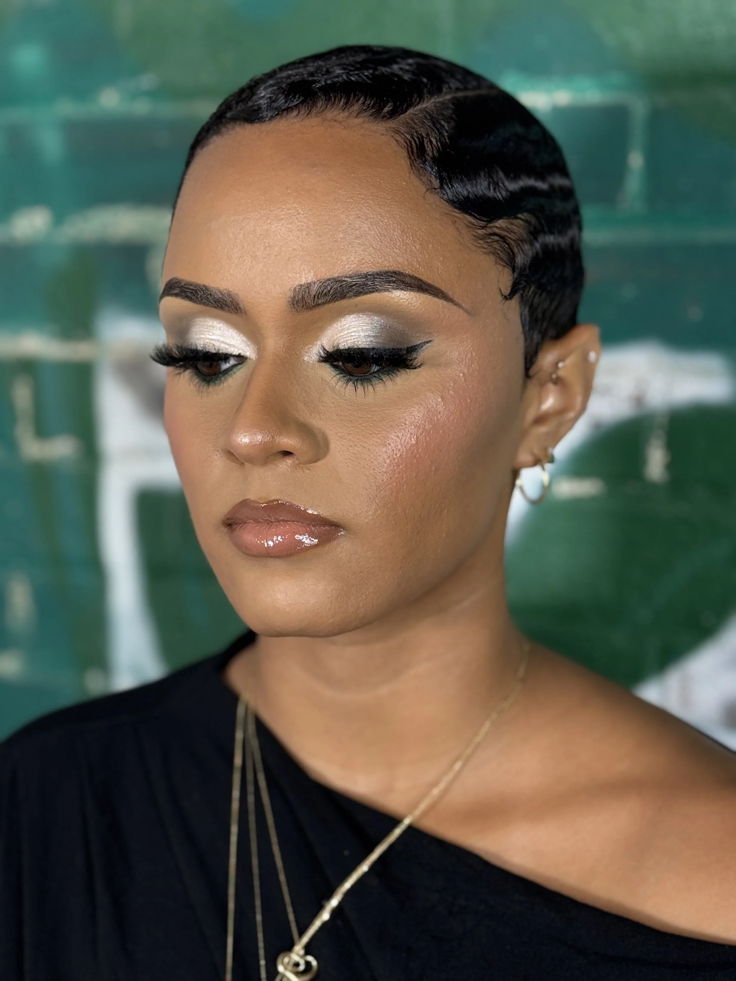 Person wearing a blue "Adulting" shirt with styled hair and makeup.