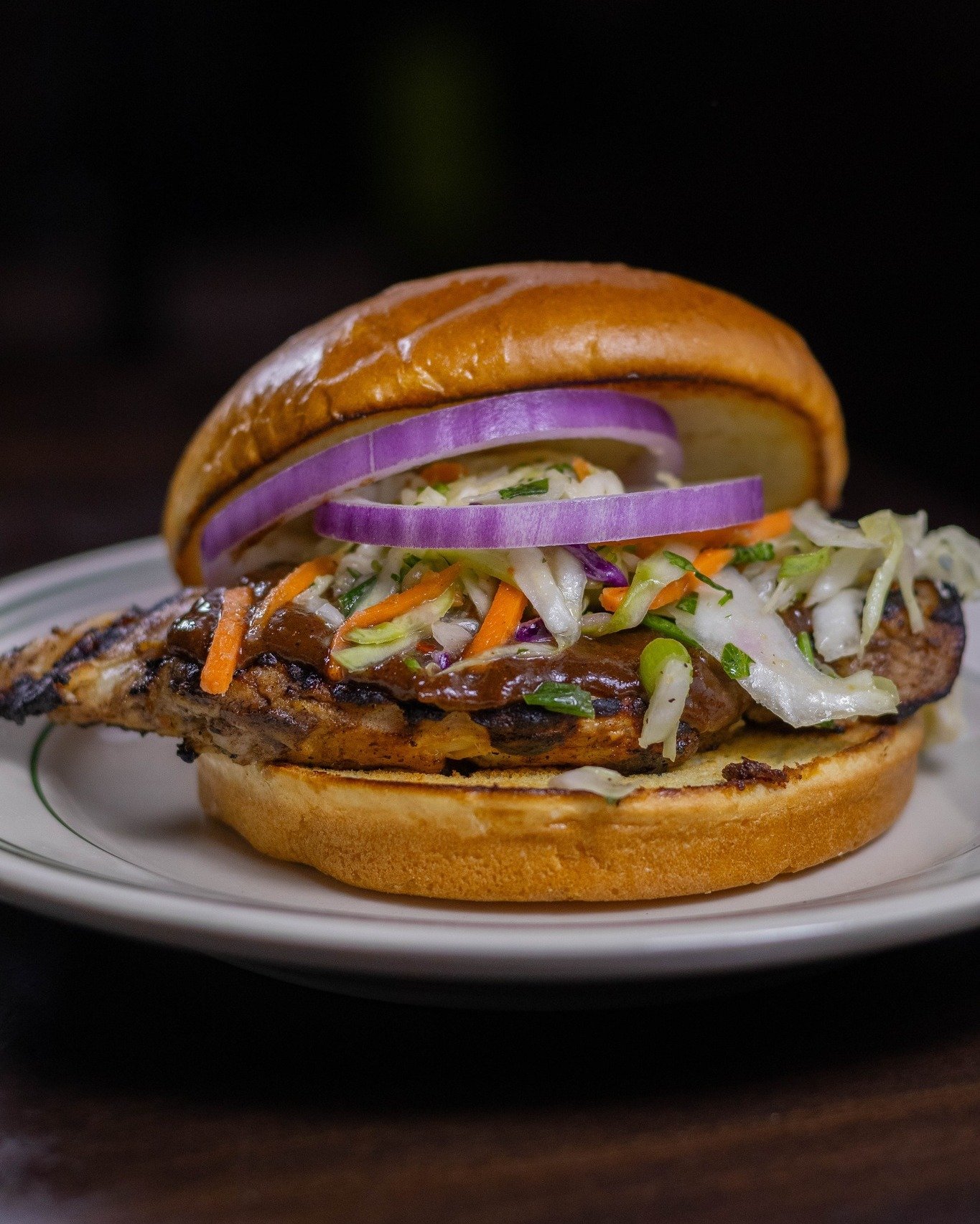 We spiced up a classic grilled chicken sandwich with jerk marinade, ginger slaw &amp; sliced red onion. Comes with your pick from a variety of side options! 🍔