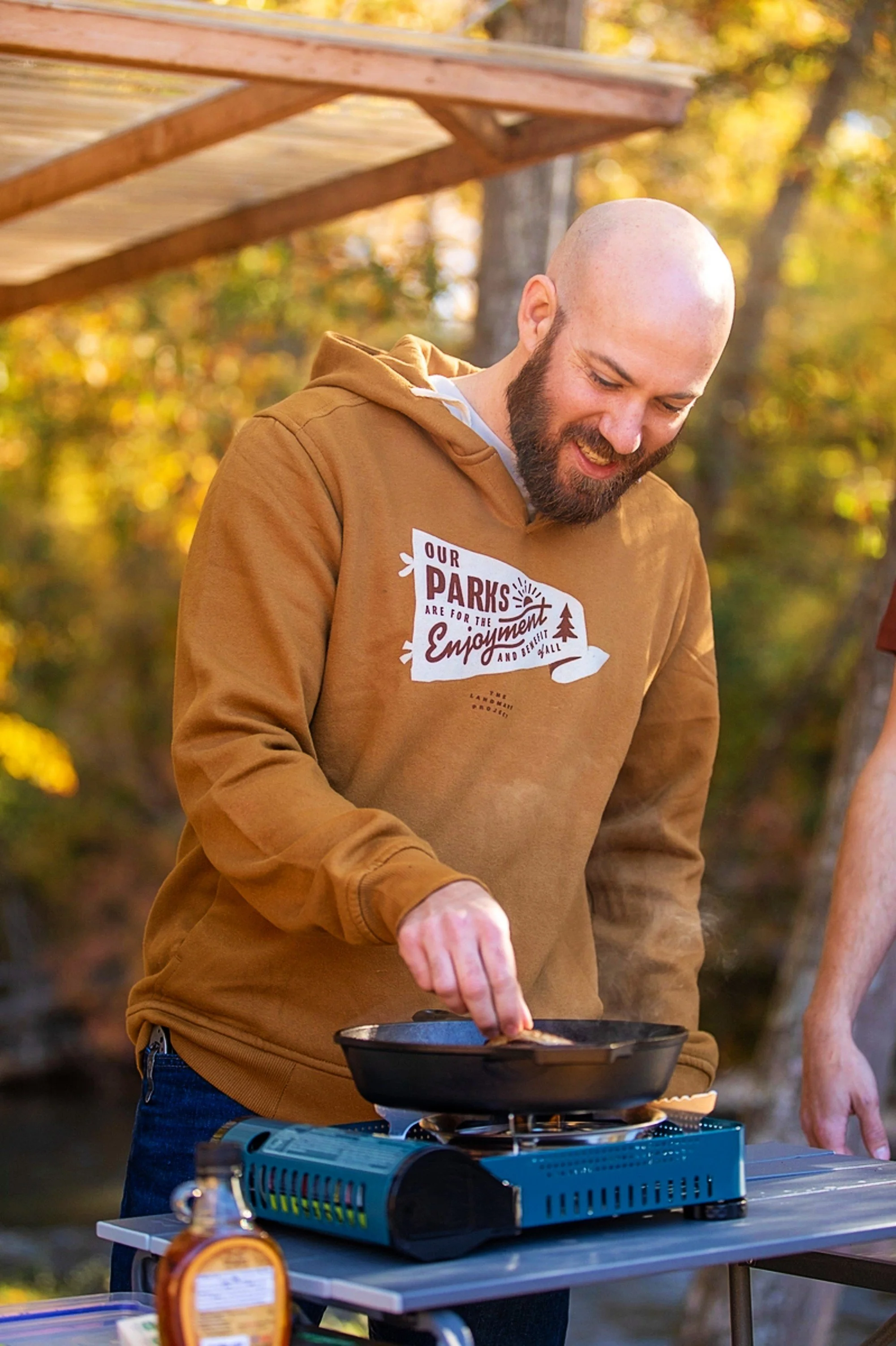 Rich ochre Our Parks pennant hooded sweatshirt by the Landmark Project features tailored details and quality craftsmanship. From lotus27inc, bringing beauty + joy to your busy life.