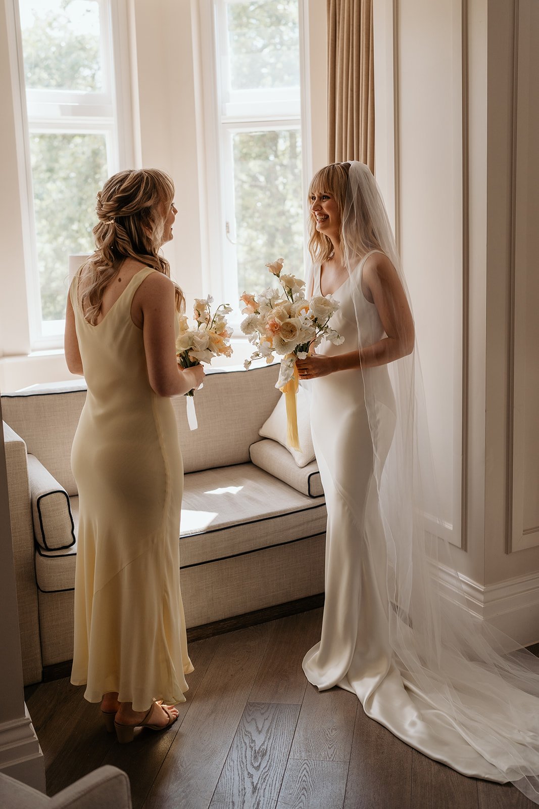 Bride and Bridesmaid holding bouquets.jpg