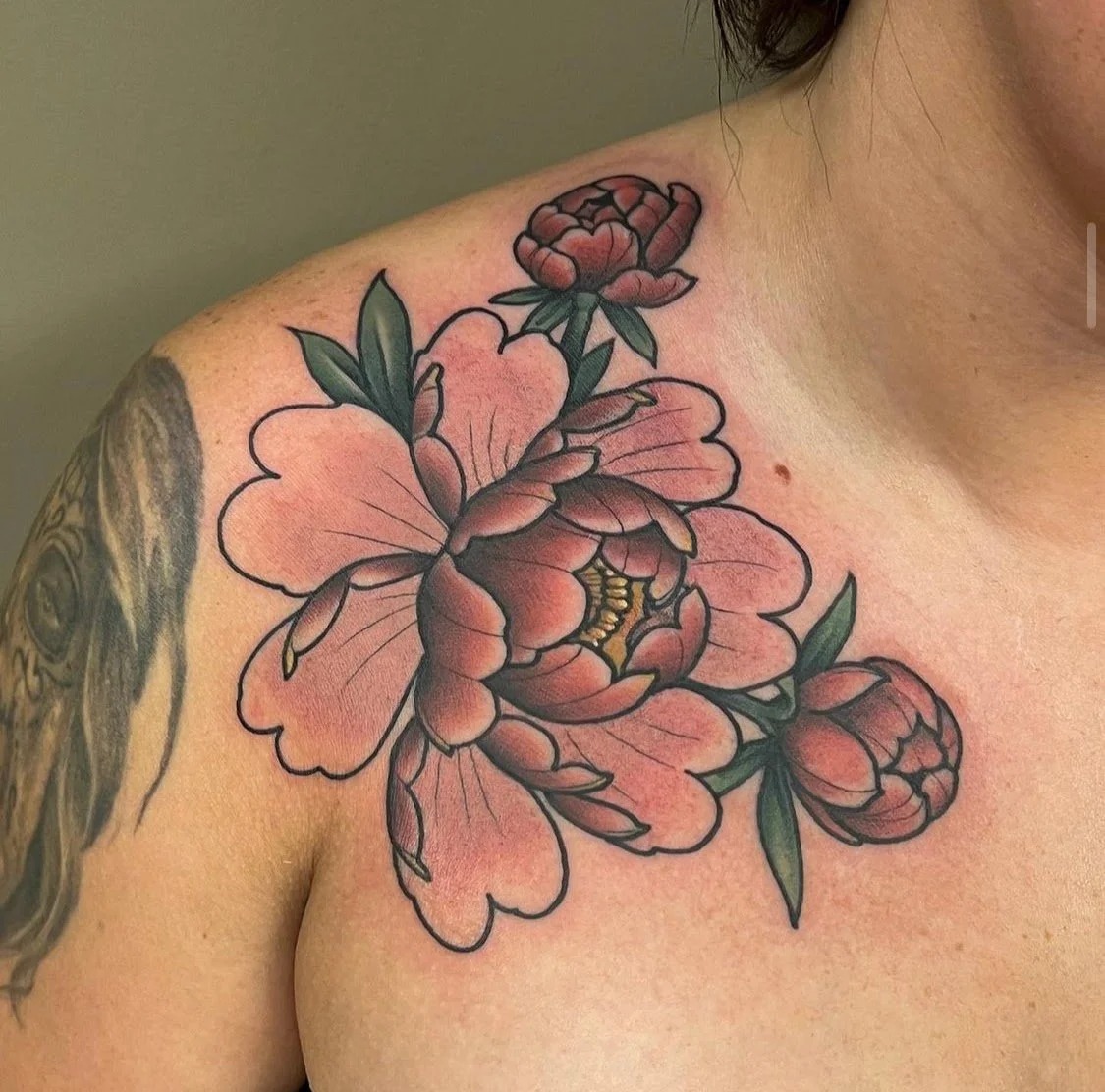 Tattoo of peony flowers on a shoulder and upper arm