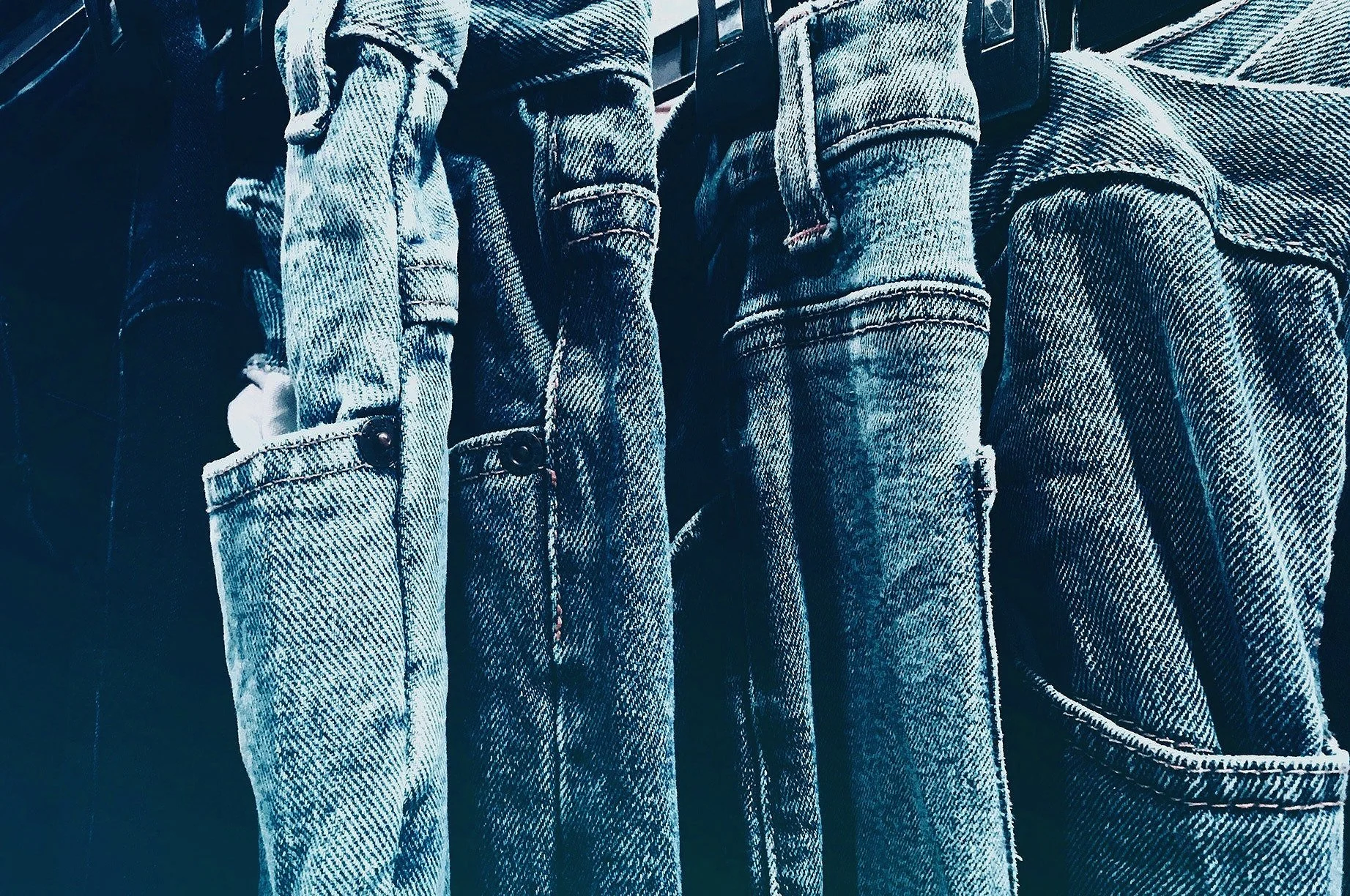 Row of jeans hanging