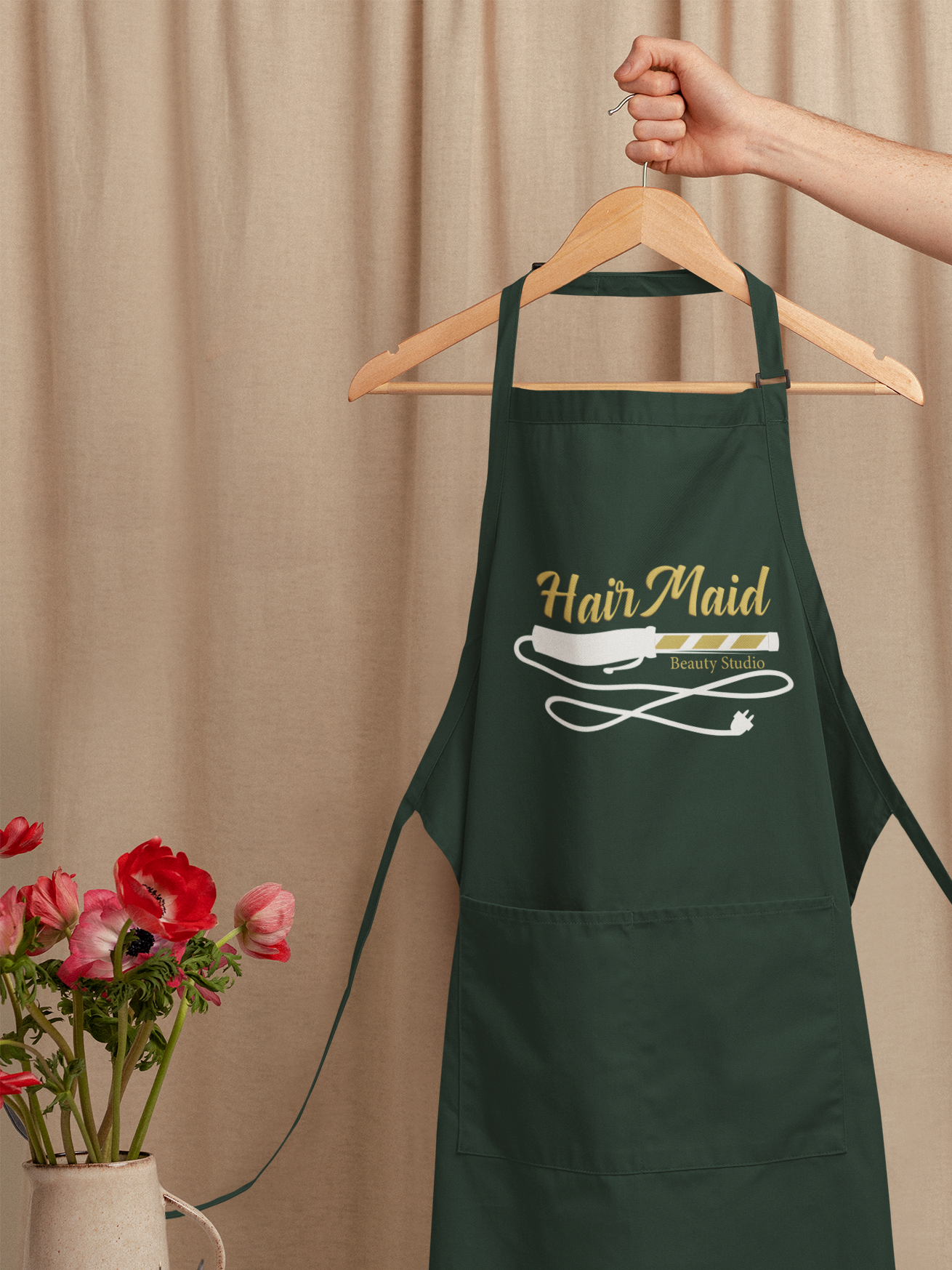 mockup-of-an-artist-s-apron-on-a-hanger-behind-a-work-table-m23517.png