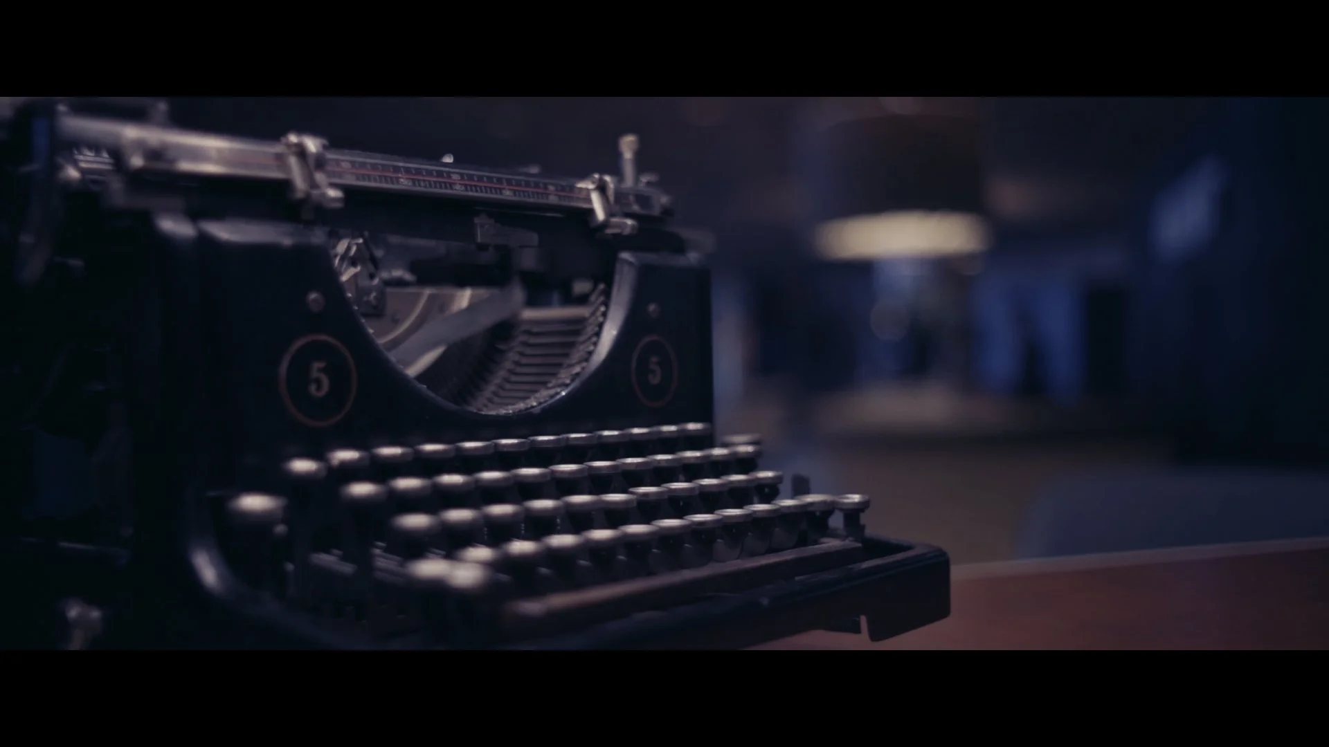 Alte Schreibmaschine aus Metall auf einem Tisch in einem dunklen Raum