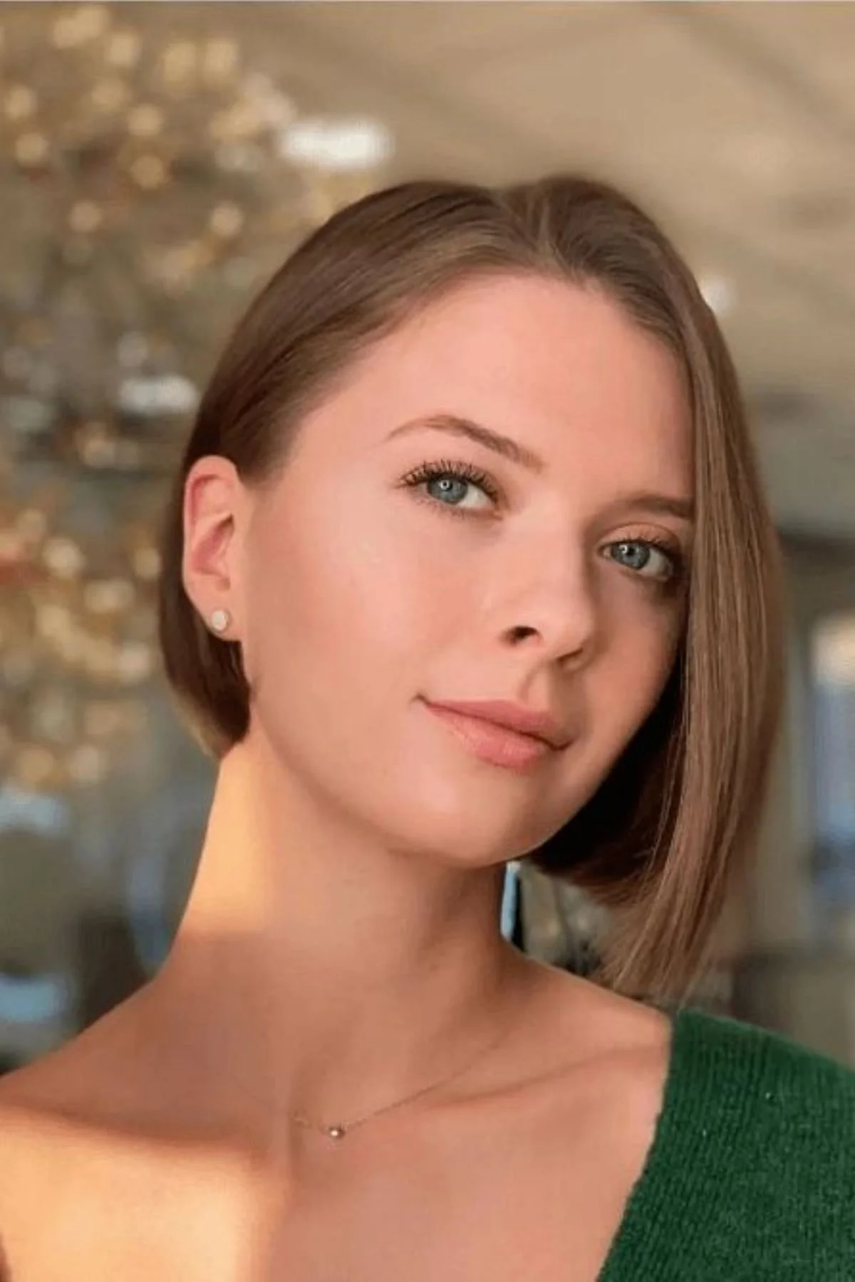 Woman with an Angled Bob (Subtle A-Line) haircut, featuring slightly longer front pieces and a sleek graduated shape.