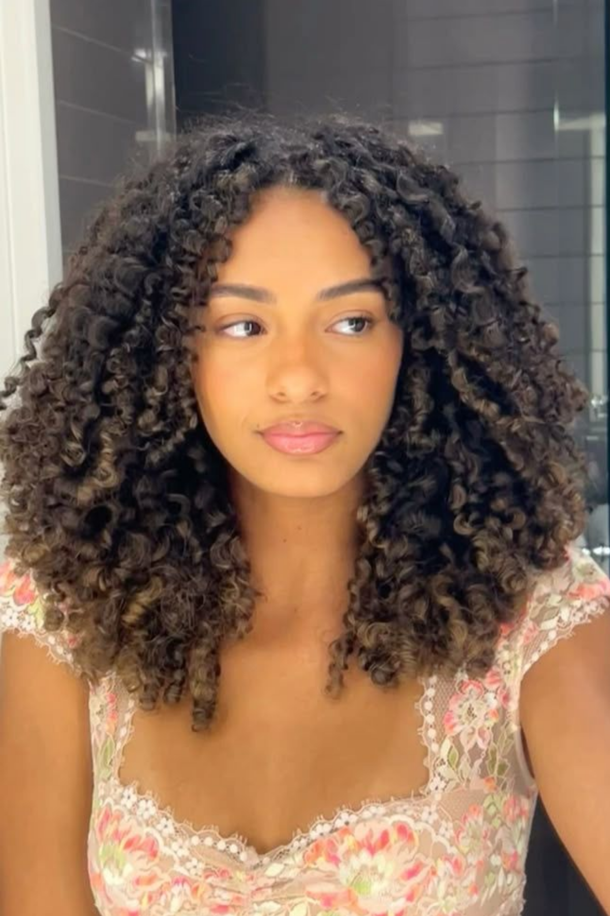 ayered medium cut on thick coily hair, defined curls, no triangle