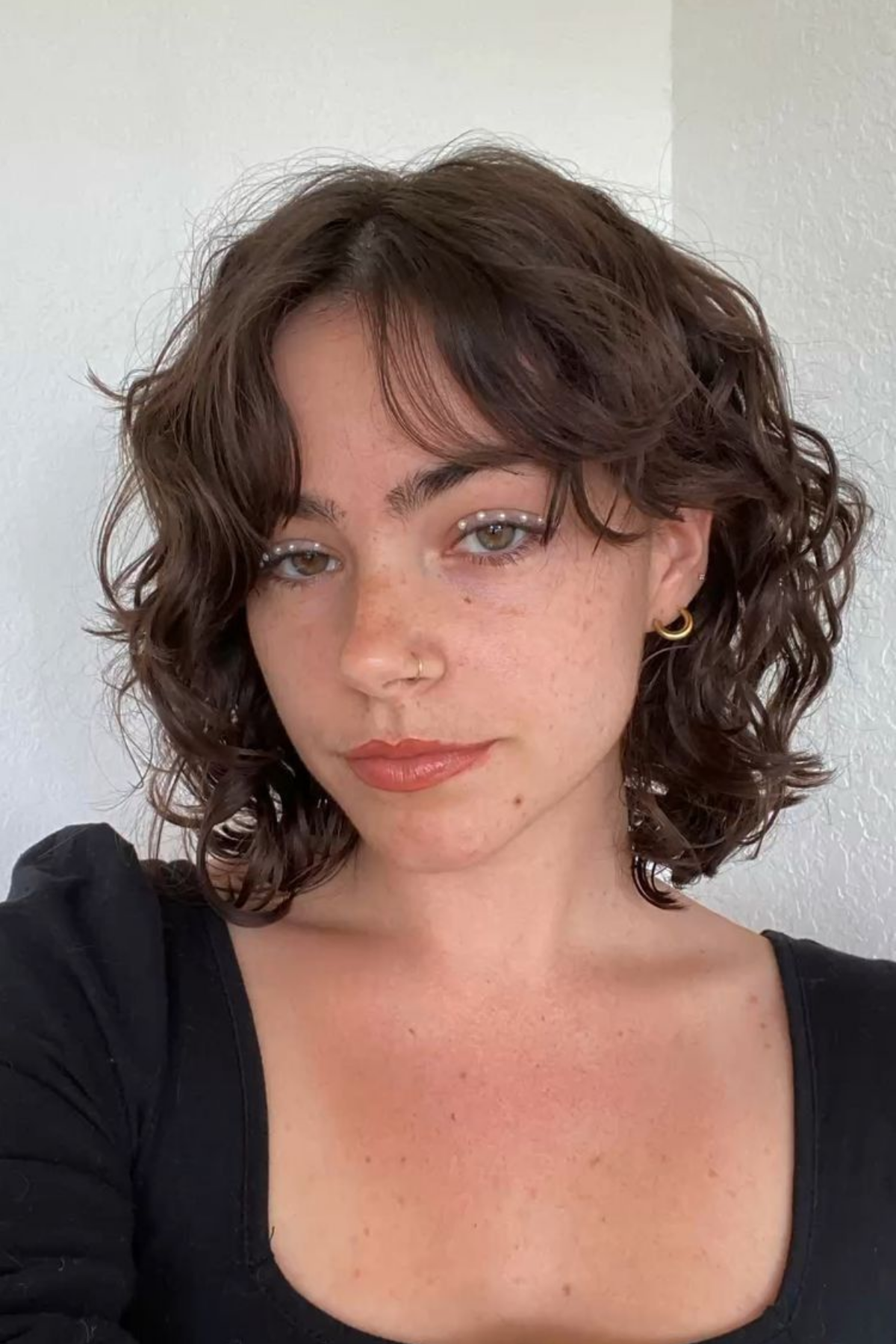 Curtain fringe on a short wavy shag feathering back into the layers