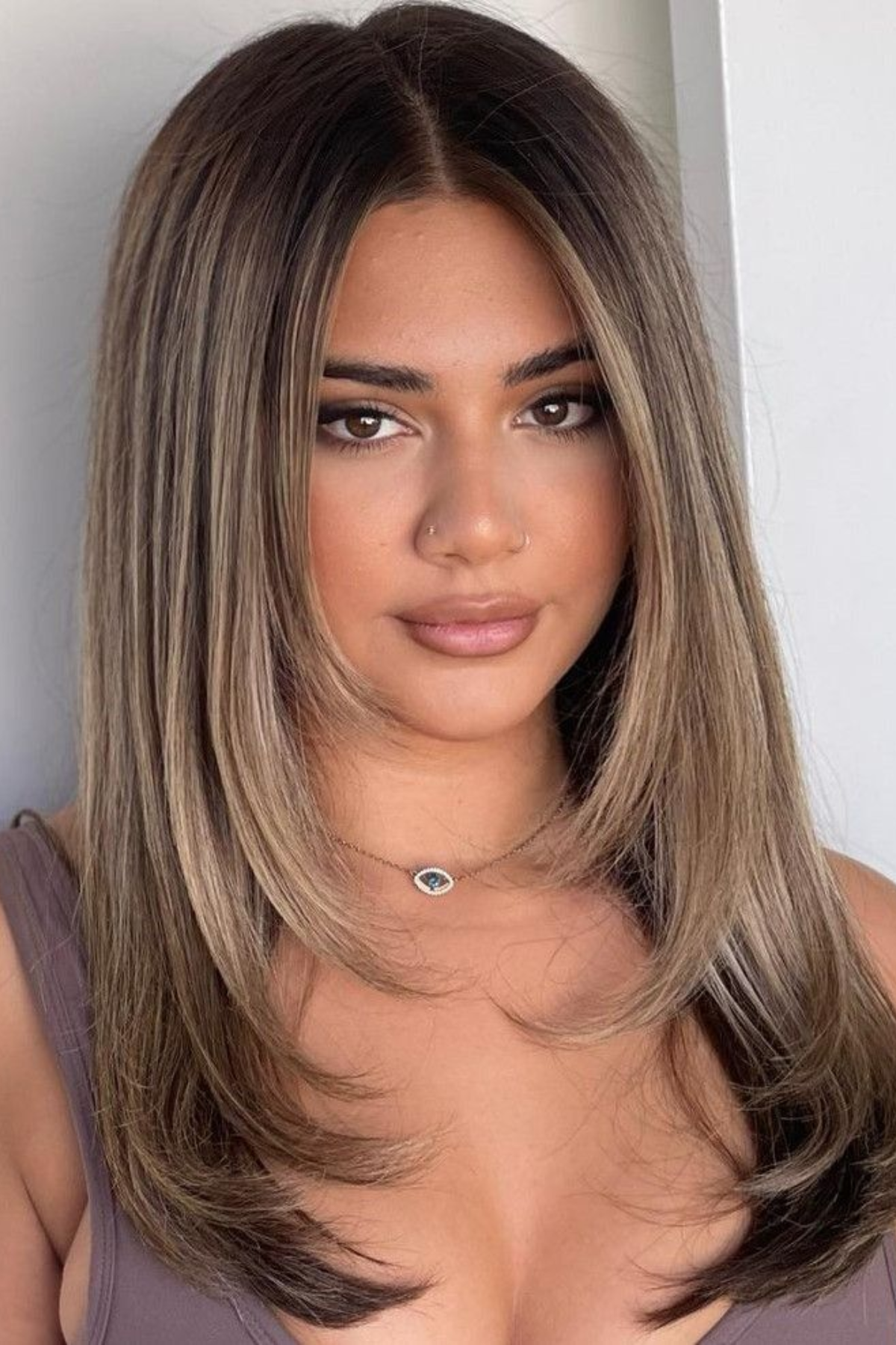 Girl with Face-Framing Layers haircut, highlighting lighter front sections that keep hair off the face in hot weather.