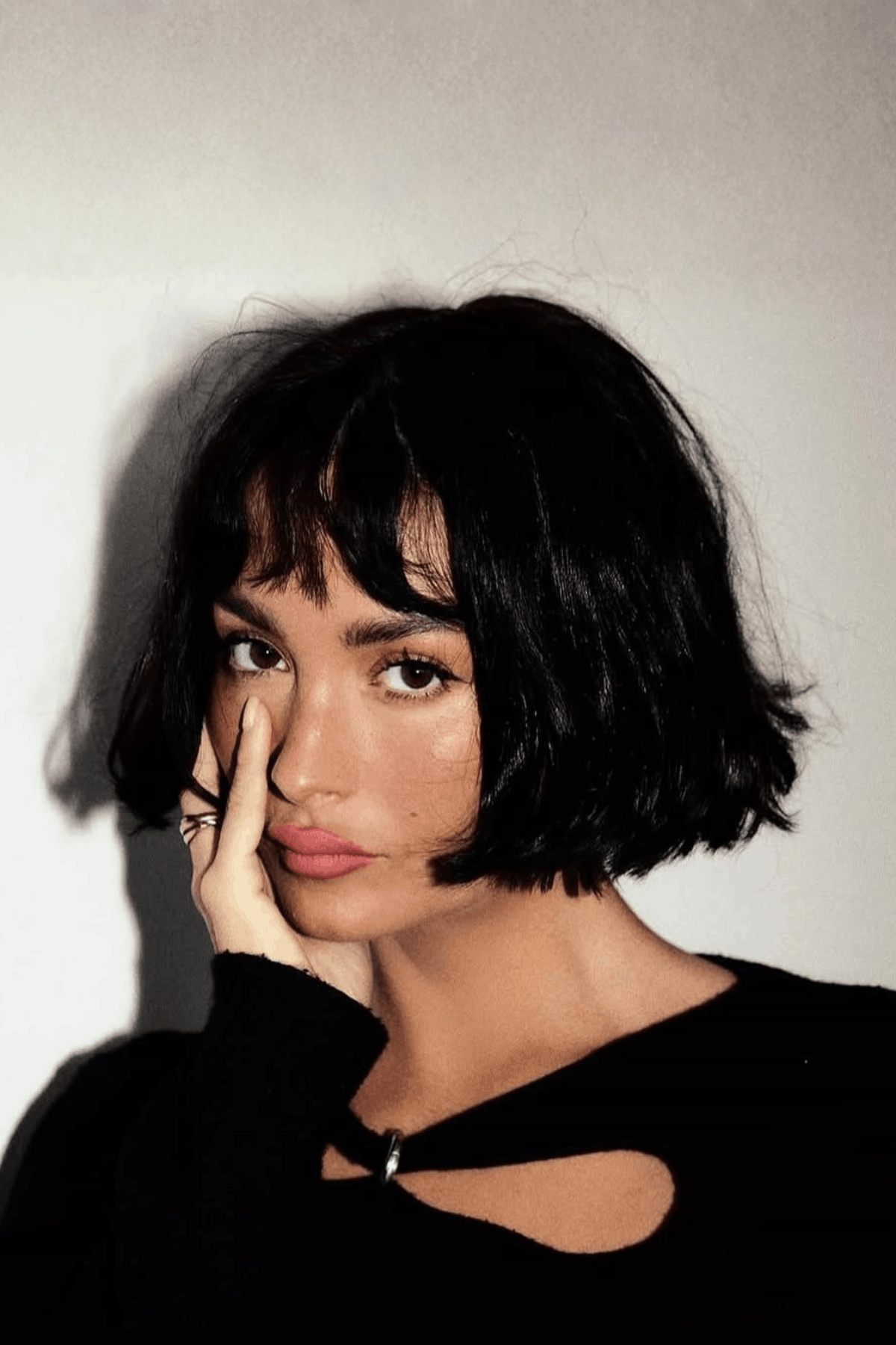 Front-facing image of a person wearing The Layered French Girl Bob, characterized by a short bob with natural texture, light layering, and a relaxed fringe for an effortless look.