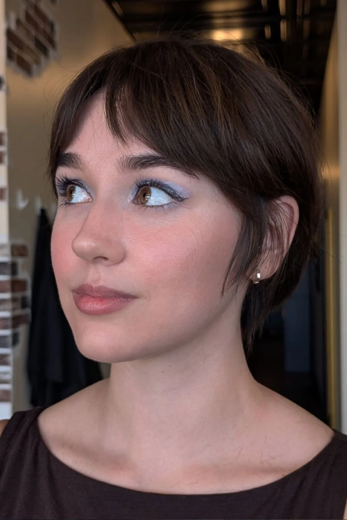 Woman with a Classic Short Bixie haircut, showcasing a timeless mix of pixie shortness and bob structure.