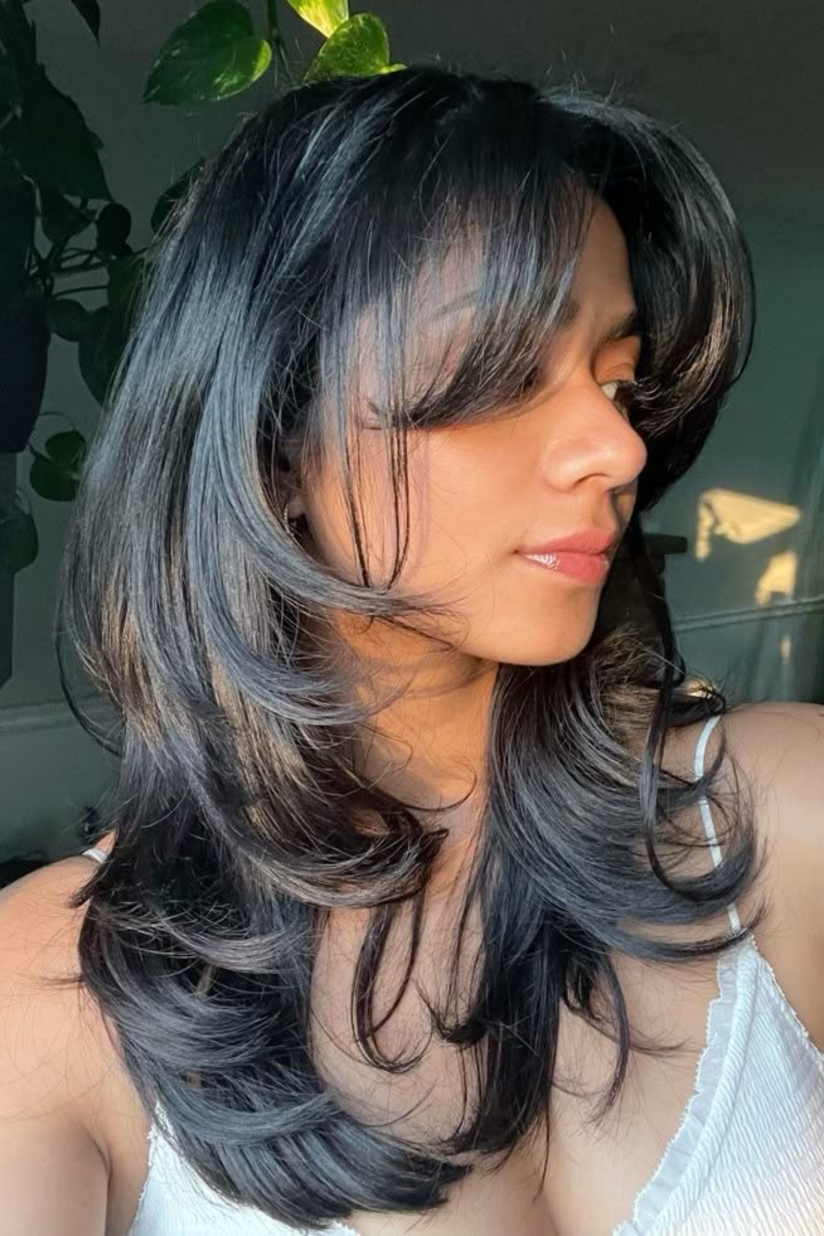 Girl styled in a Butterfly Haircut with Airy Layers, showcasing cascading feathered layers that create light volume and flow.