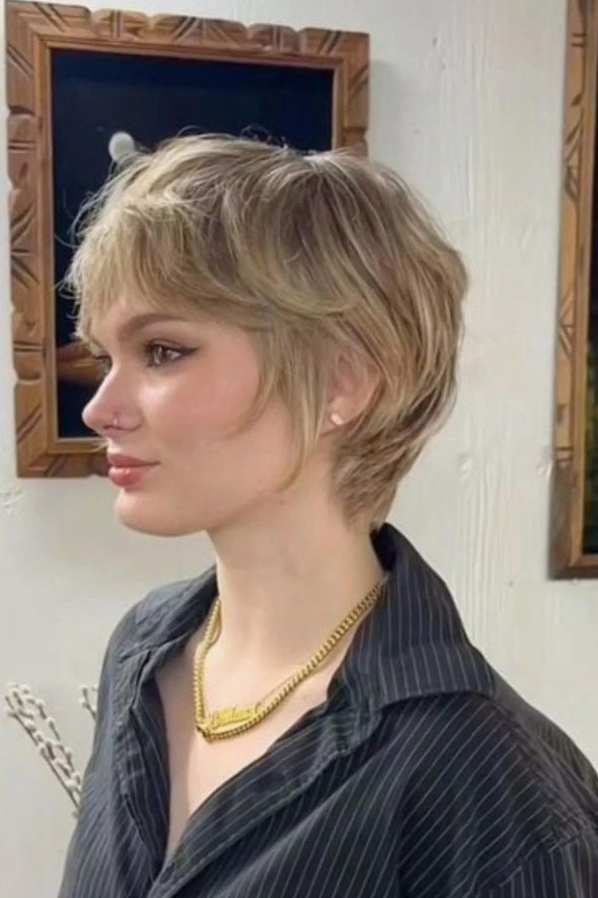 Girl wearing a Feathered Bixie haircut, featuring soft feathered layers that add lightness and movement.