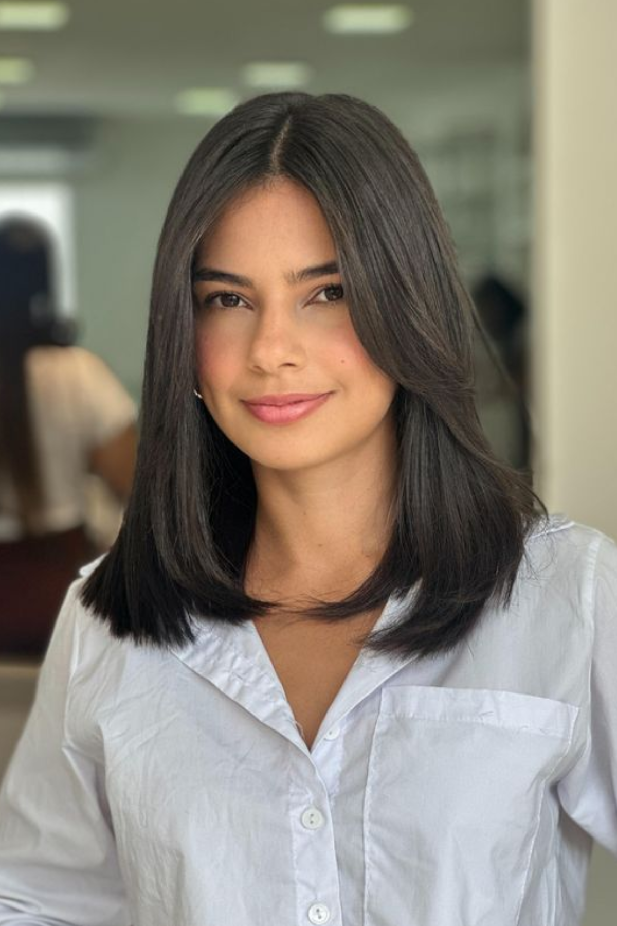 Woman with Invisible Layers haircut, featuring subtle layering that creates movement without sacrificing fullness.