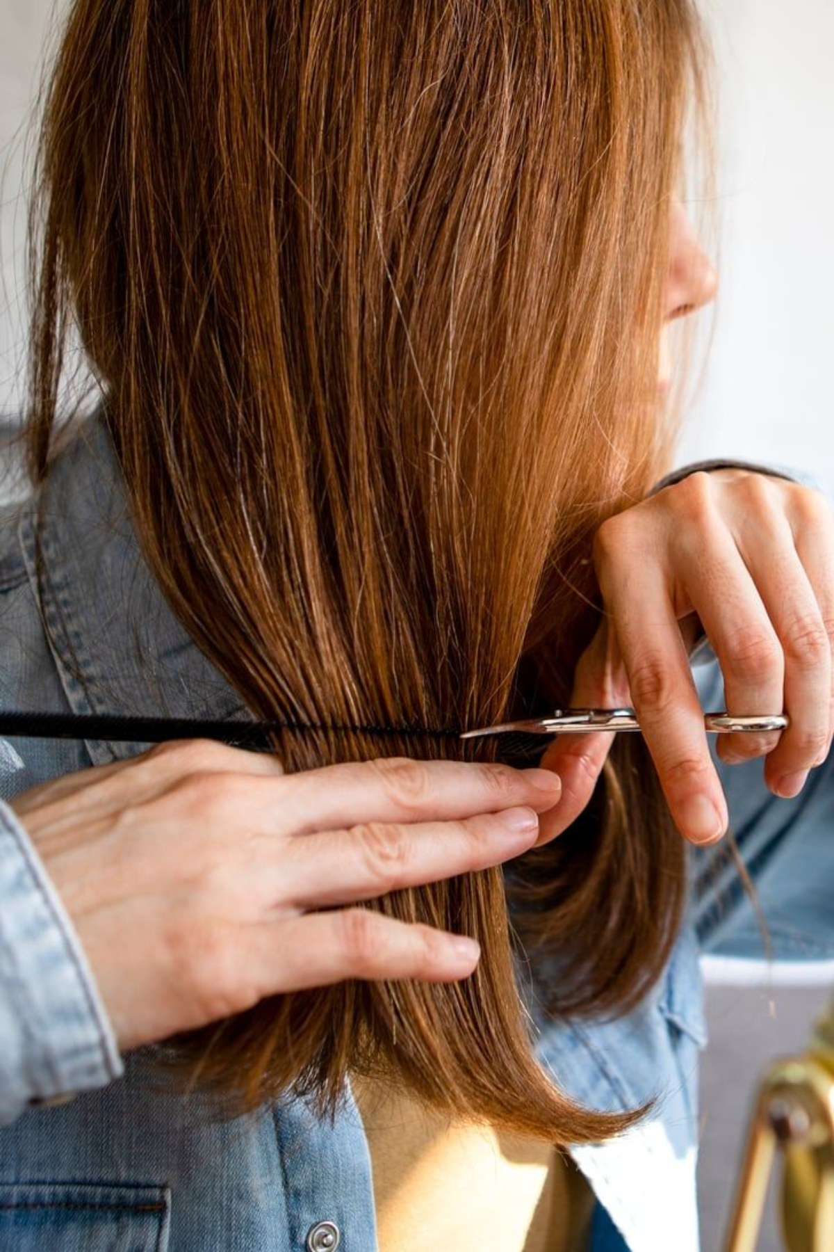 A Girl trying to cut her ends
