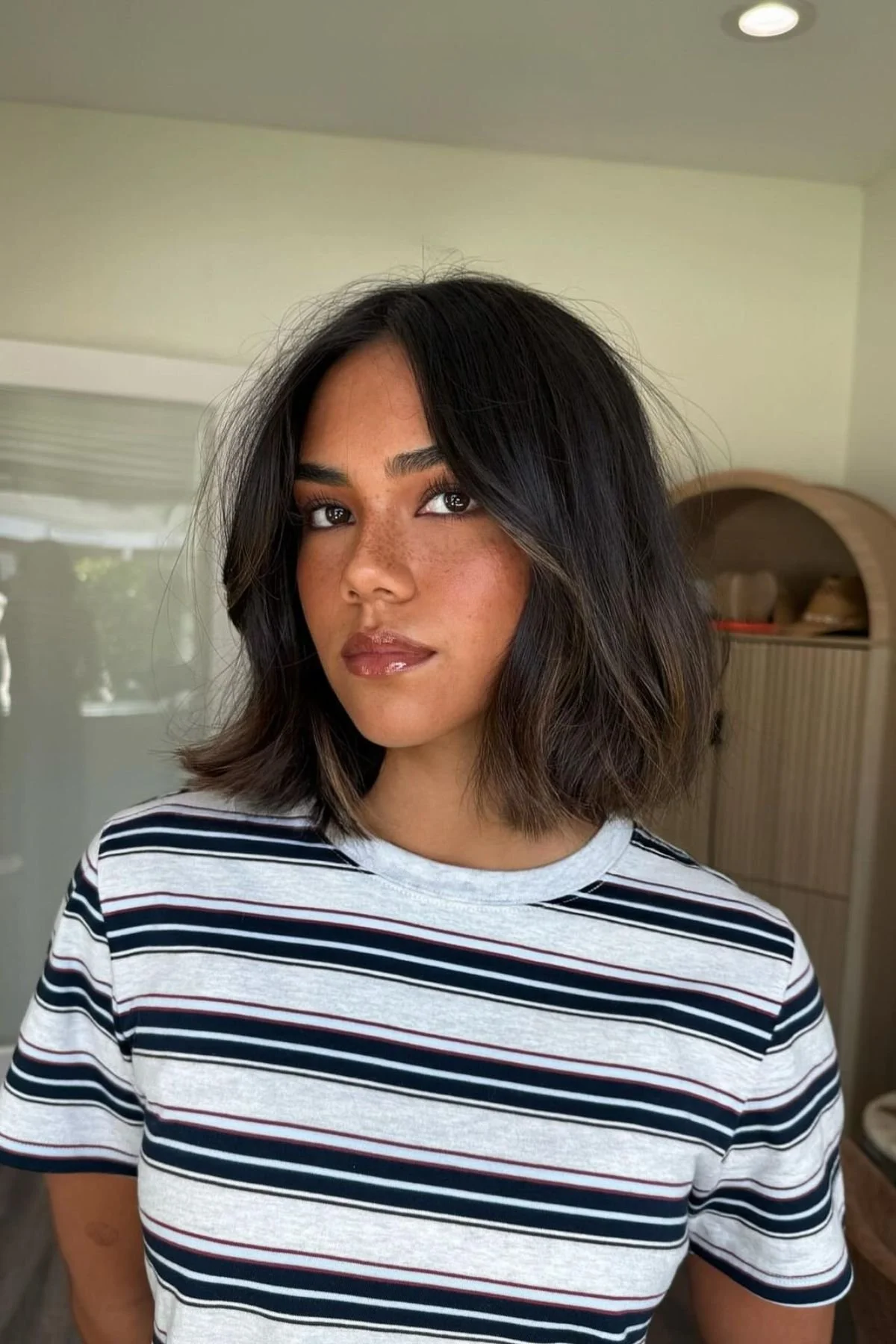 Woman with a Shoulder-Length Lob (Long Bob) haircut, showcasing a sleek mid-length cut with soft movement and versatility.