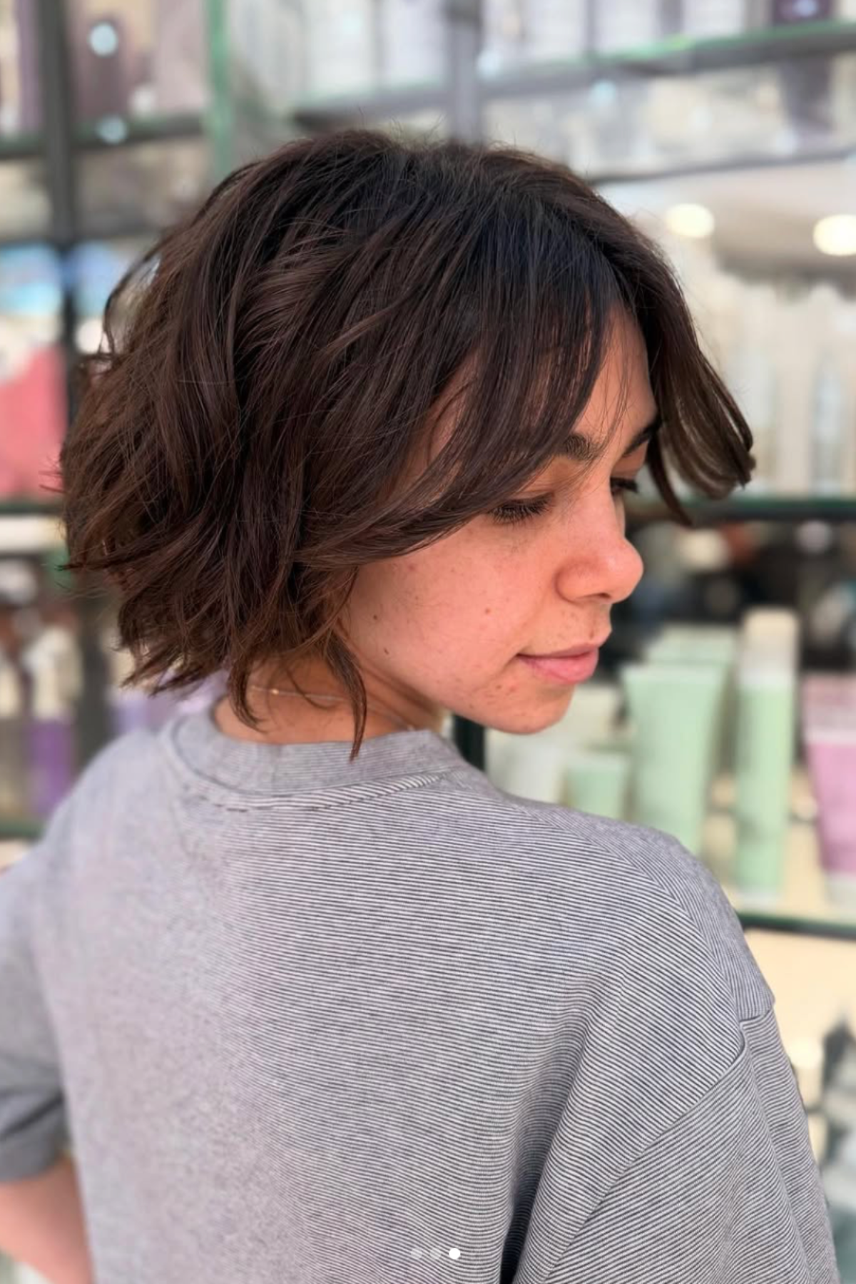 Woman with a Bixie Cut (Bob + Pixie Hybrid) haircut blending short pixie layers with the rounded shape of a bob.