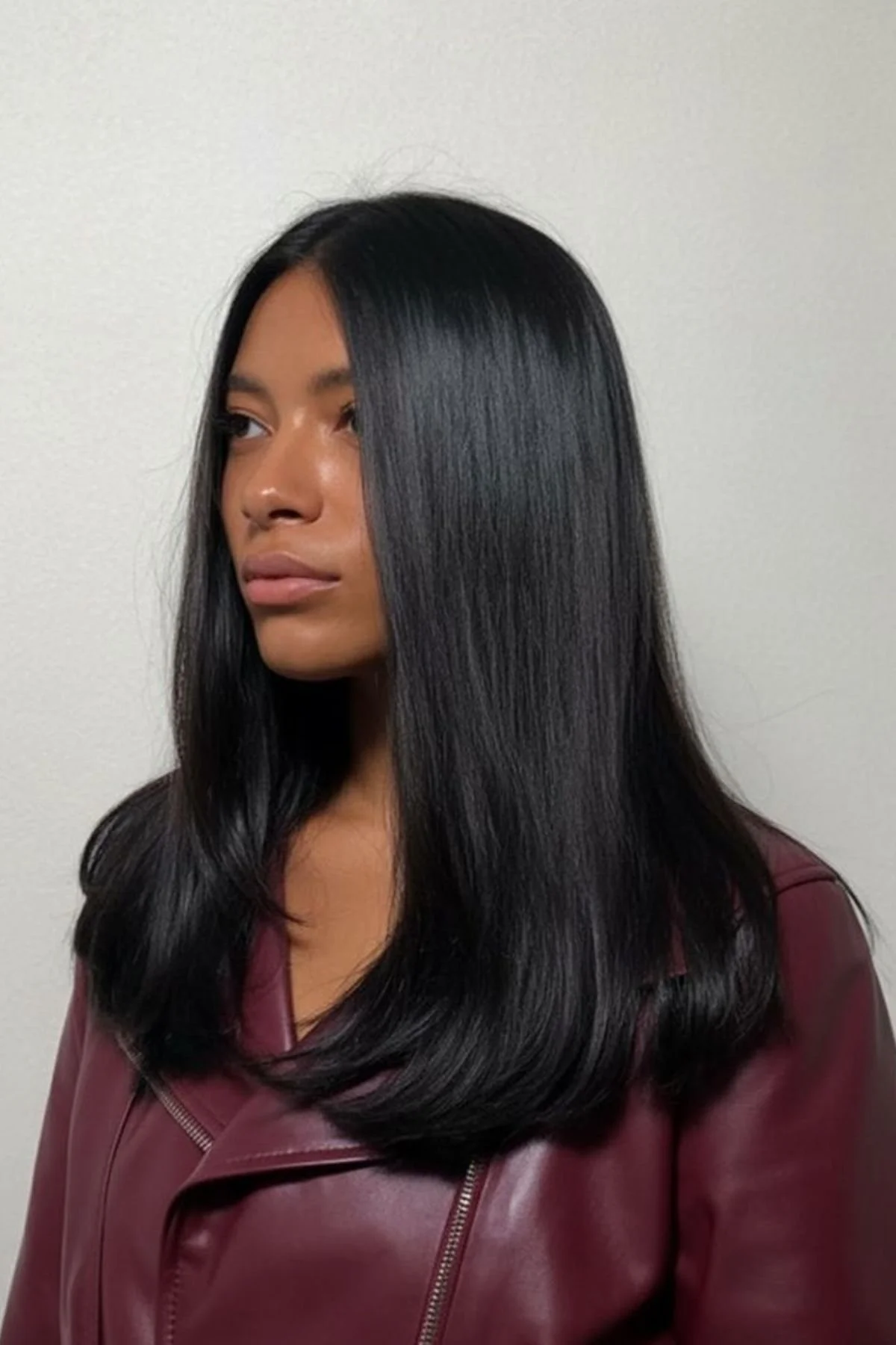 Woman styled in Long Layers with Minimal Maintenance haircut, featuring soft long layers that enhance movement without daily styling.