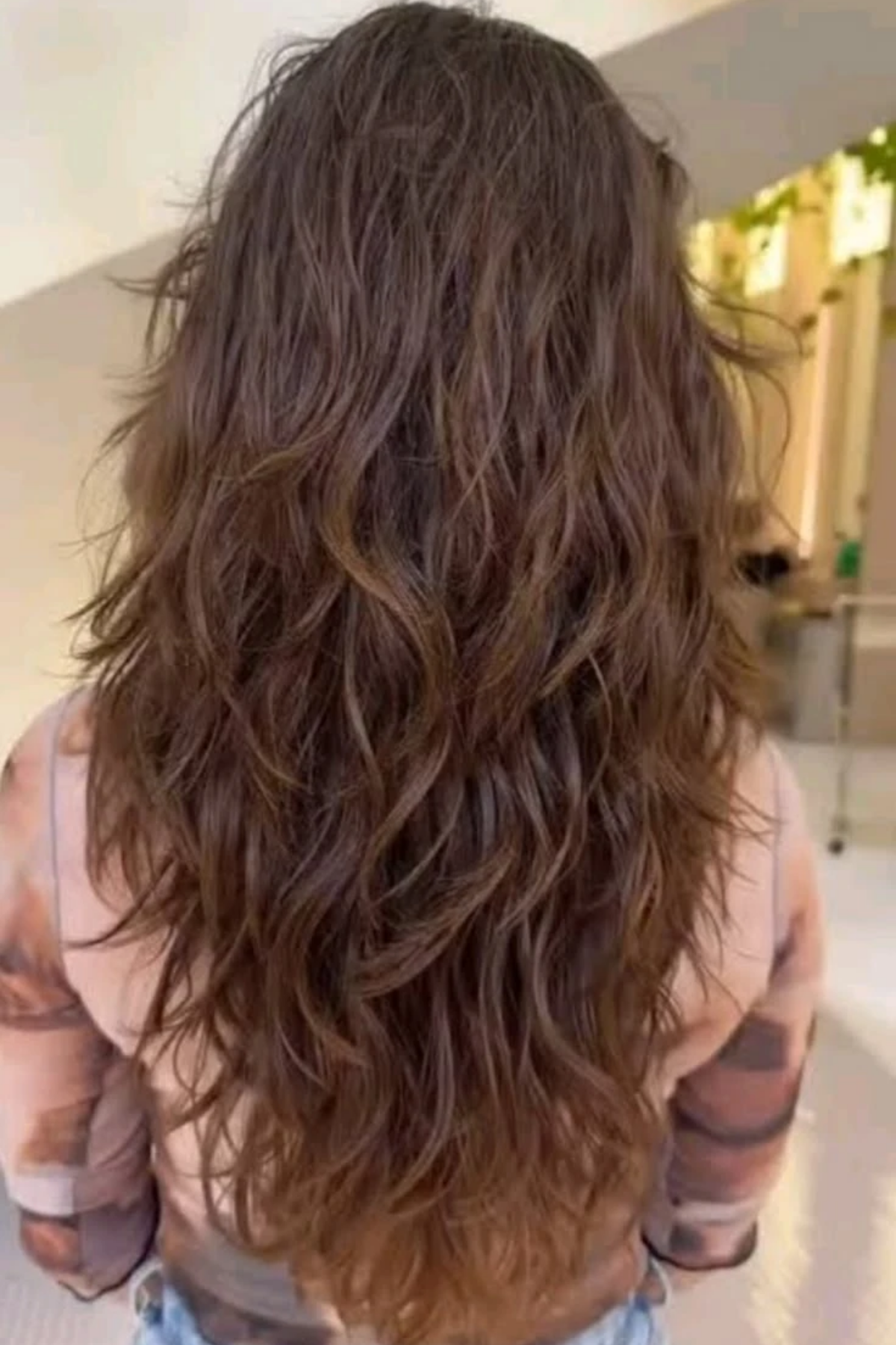 Long hair kept long on thick hair with the weight layered out