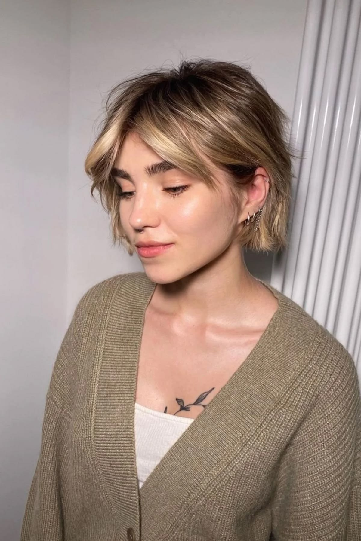Grown-out pixie shaped into a deliberate cut with face-framing pieces