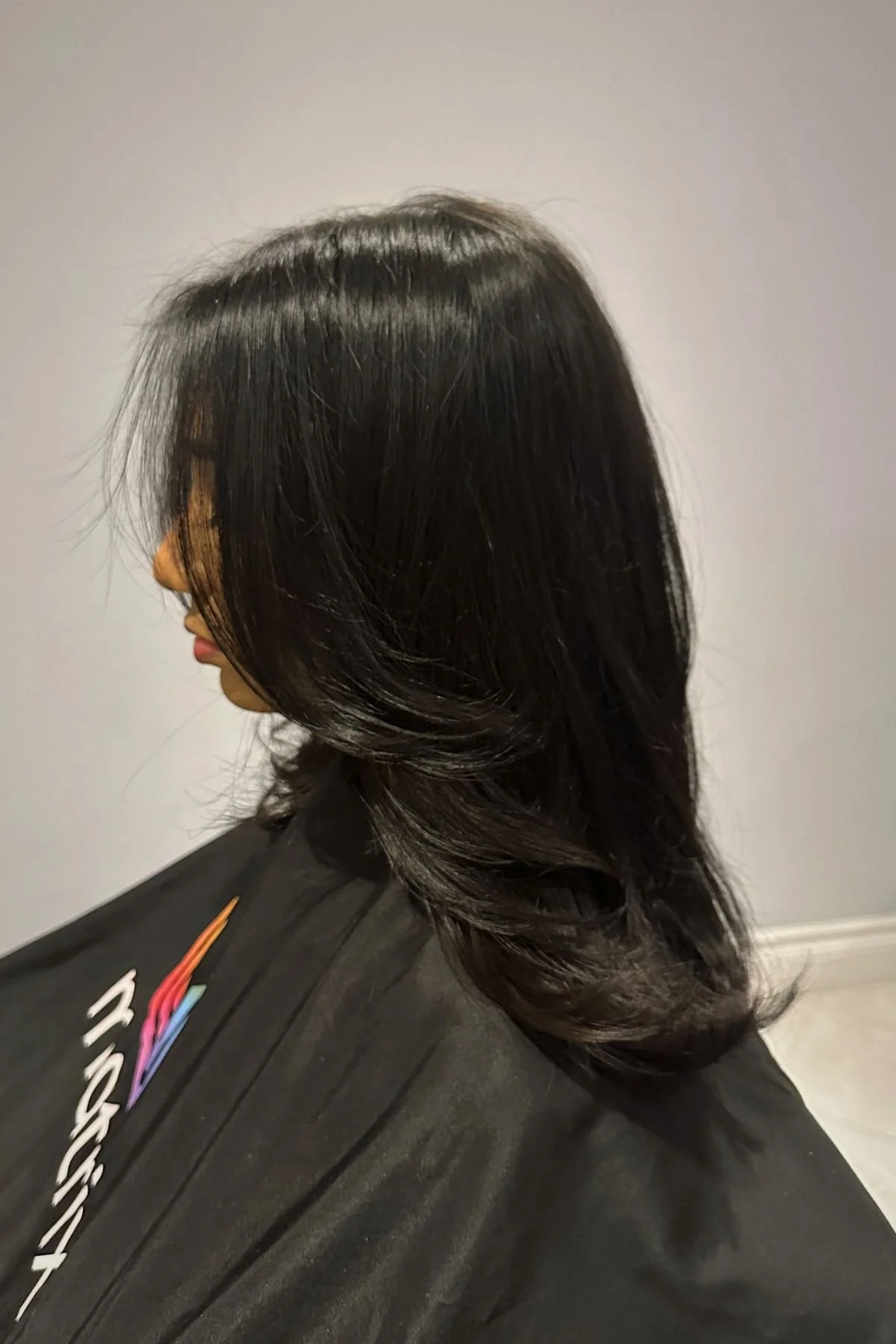 woman wearing a shoulder-length cut enhanced with delicate face-framing layers that add dimension