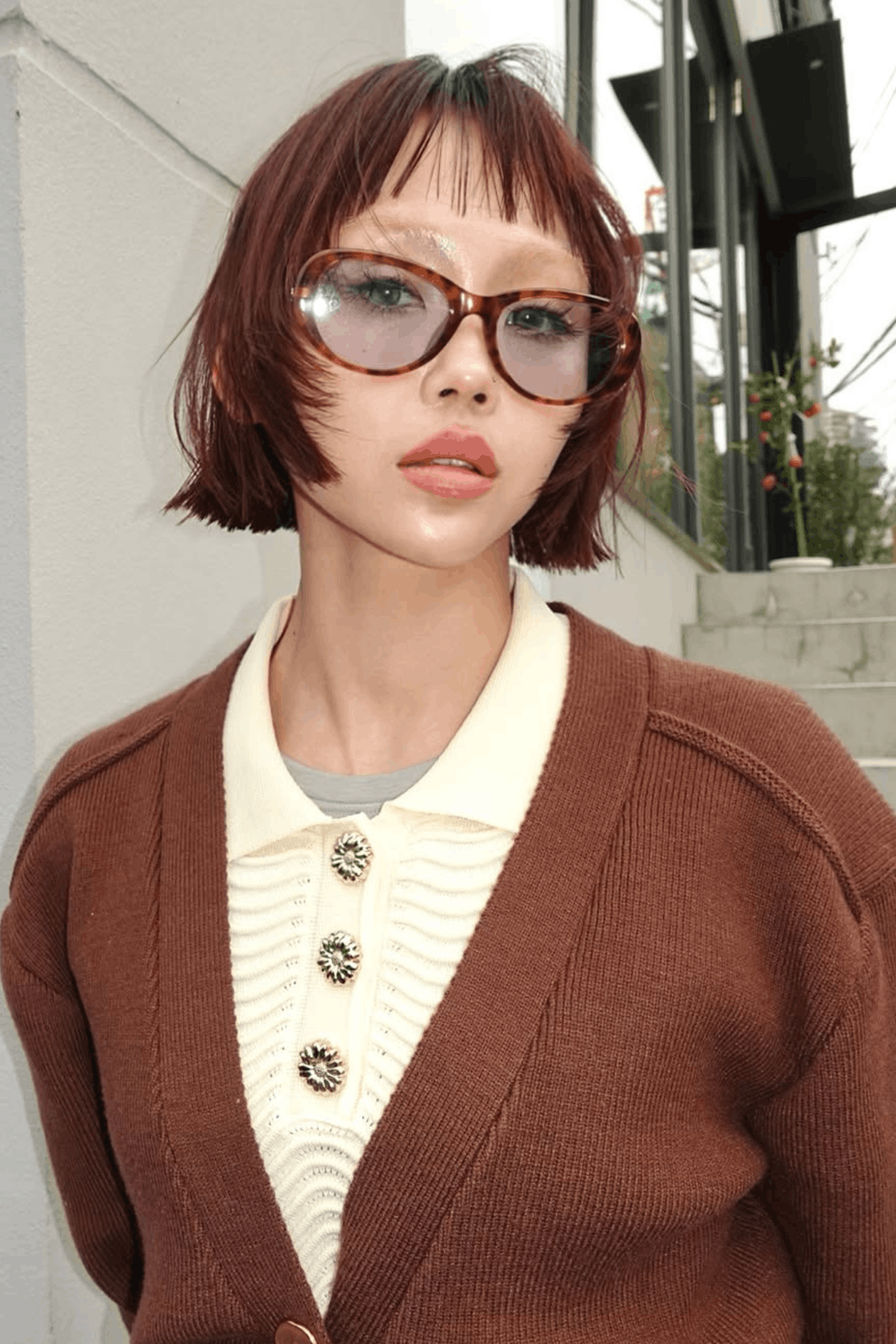 Front-facing image of a person wearing The Undone Razor Layers Cut, defined by razor-cut layers, uneven edges, and a deliberately imperfect, lived-in texture.