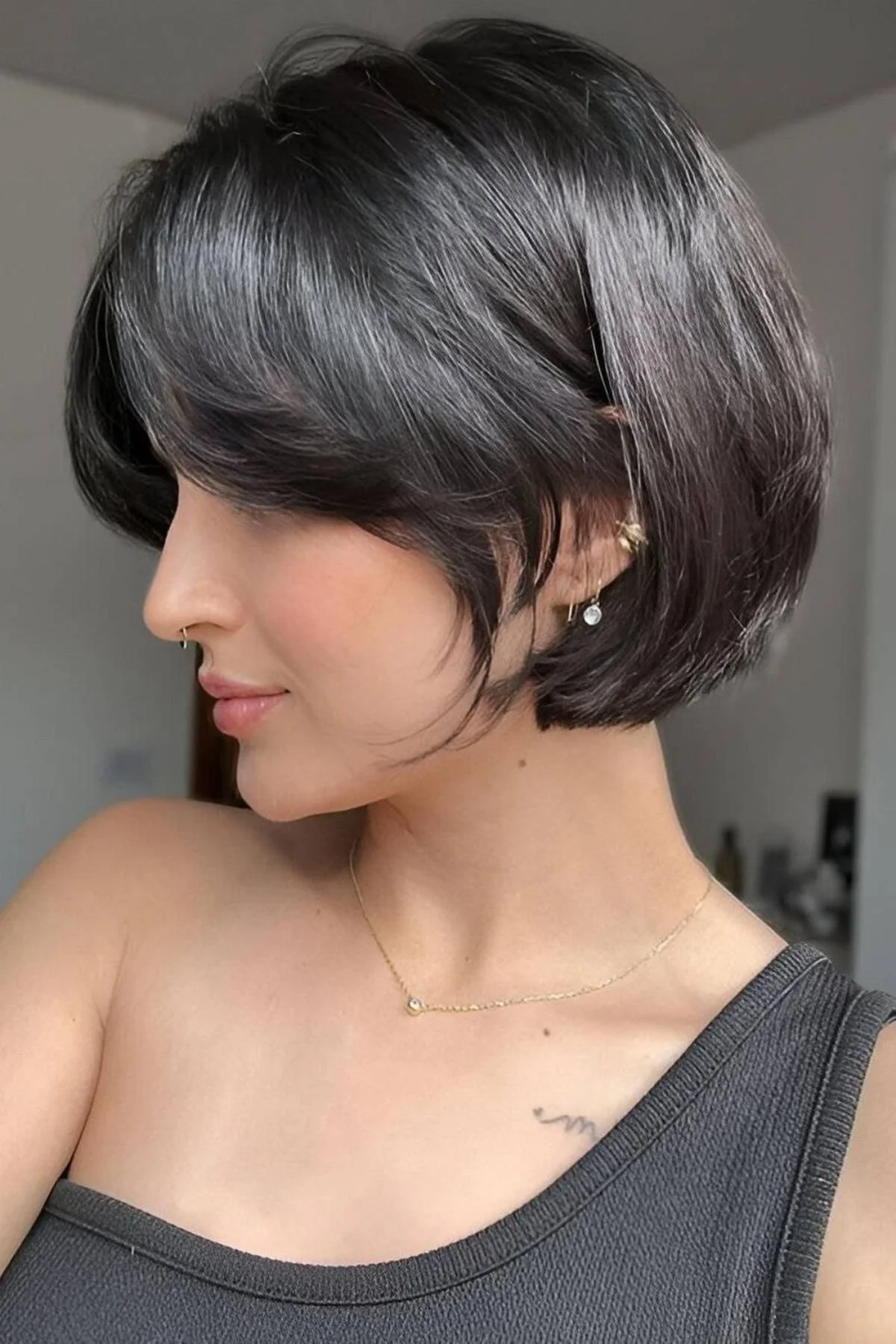 Girl wearing a Classic Chin-Length Bob haircut with sleek structured ends sitting perfectly at the jawline.