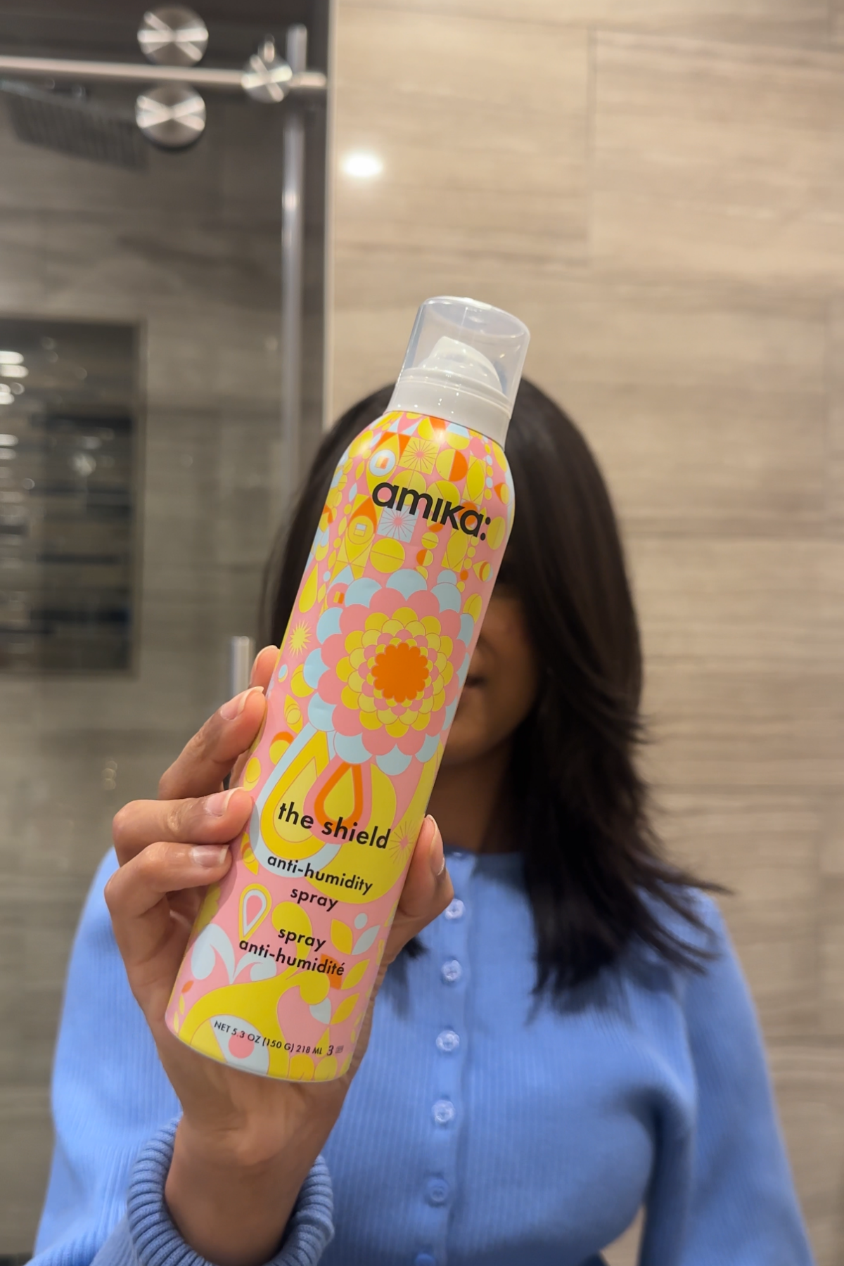 Jen holding Amika The Shield Anti-Humidity Spray
