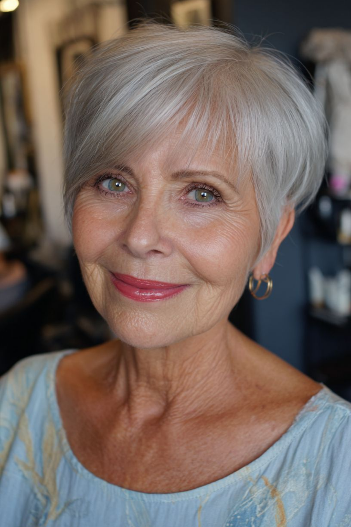 Soft textured pixie on a woman in her sixties with fine silver hair